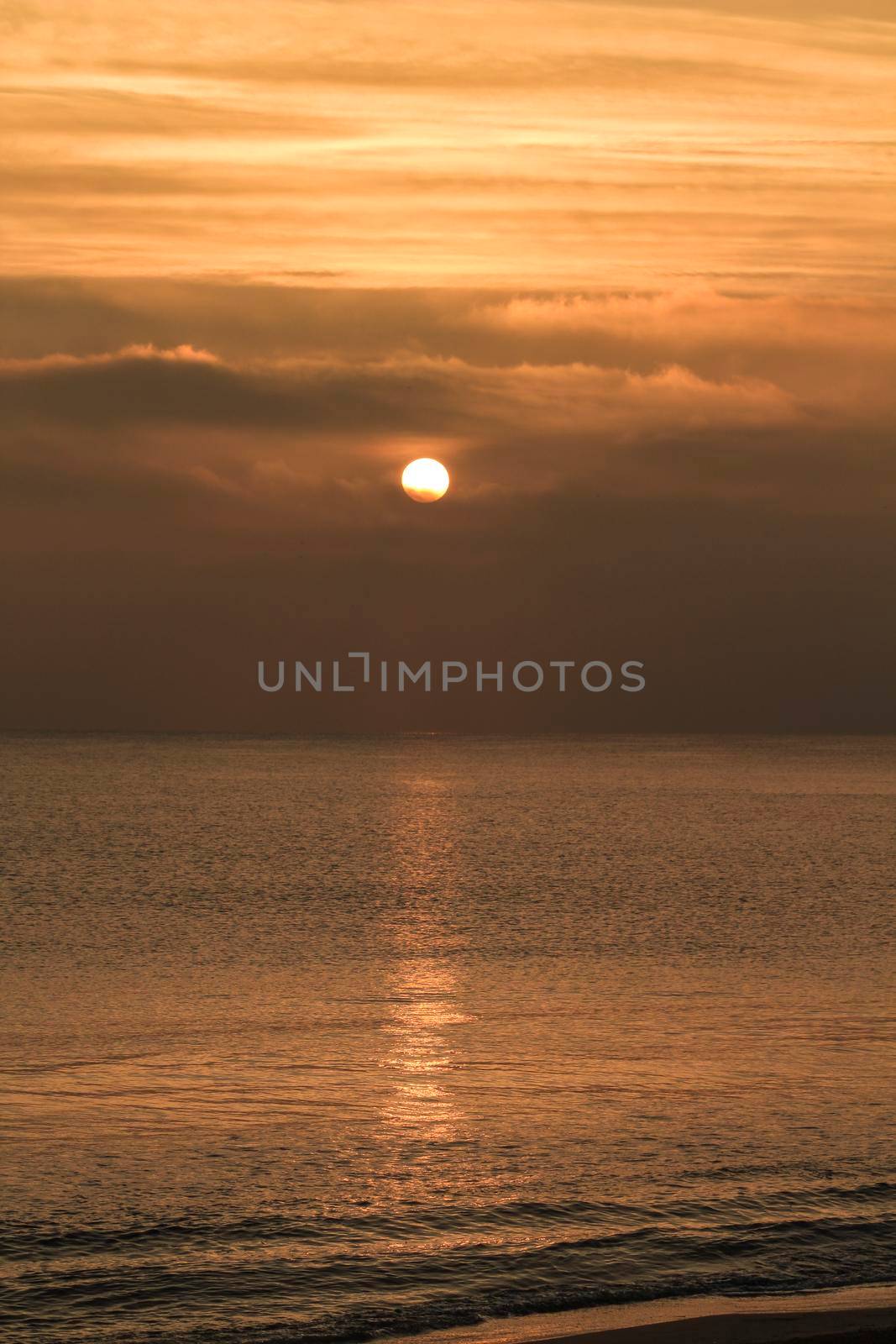Colorful sun at sunrise over the sea in southern Spain by soniabonet