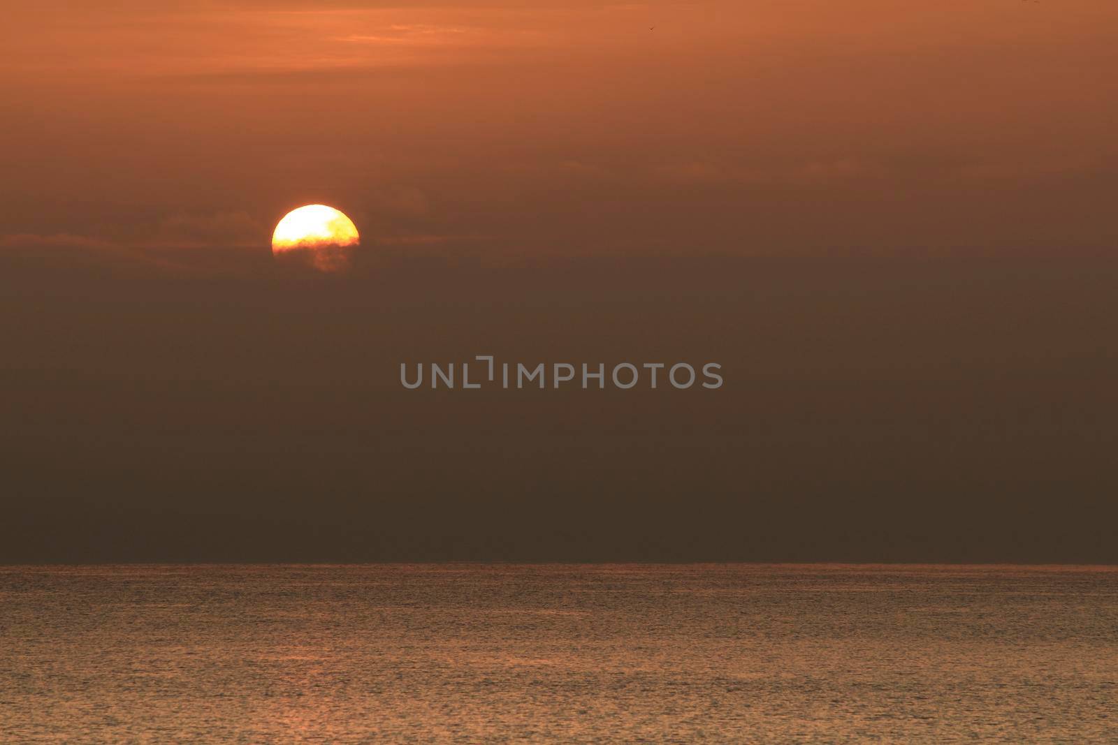 Colorful sun at sunrise over the mediterranean sea in southern Spain in Winter