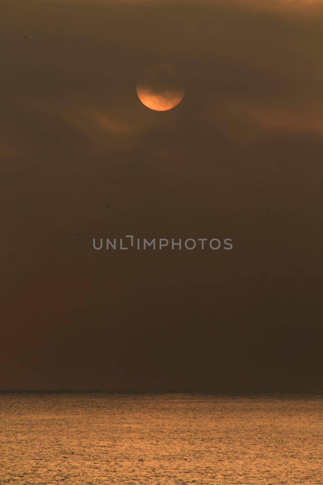 Colorful sun at sunrise over the mediterranean sea in southern Spain in Winter