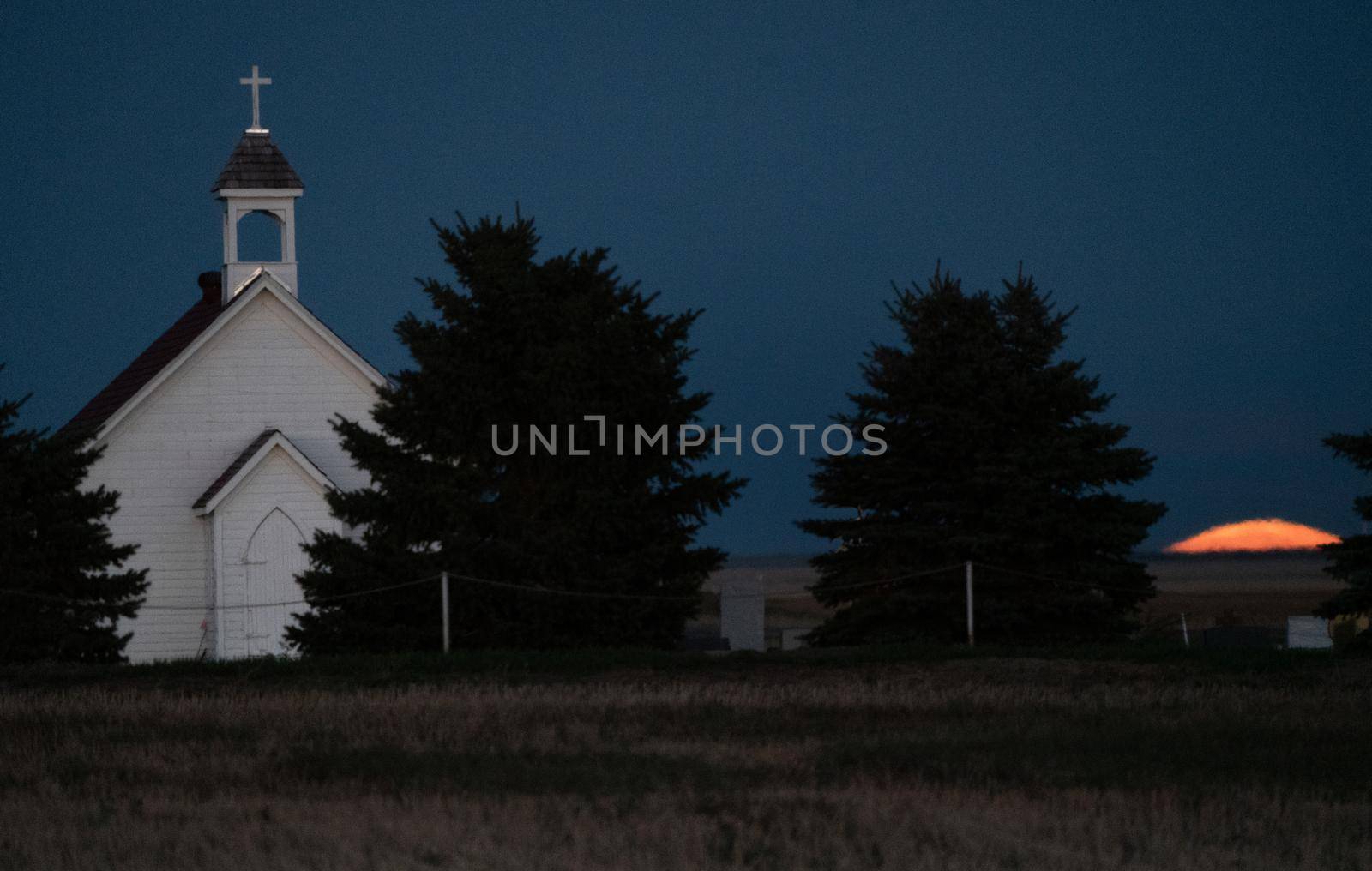 Moon rising over Prairie Country Church Canada