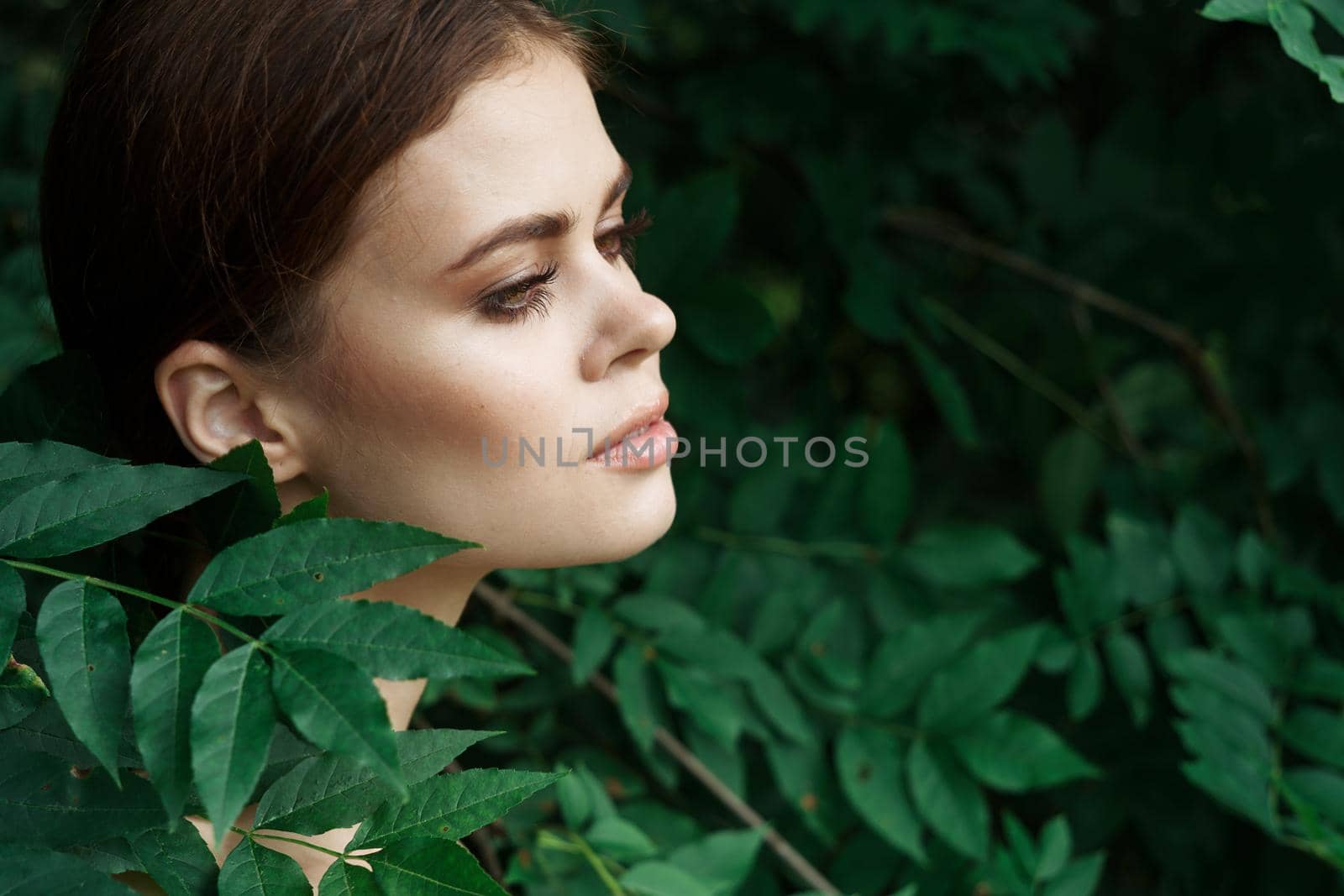 smiling woman Cosmetology nature green leaves glamor model. High quality photo