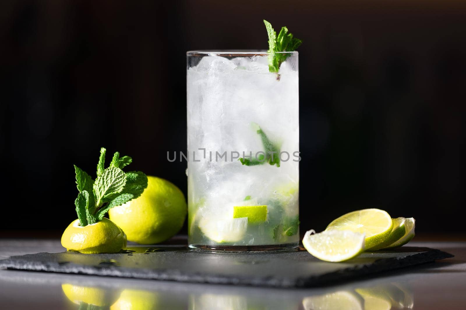 Delicious Fresh Mojito cocktail with ice, lime and mint, close-up, dolly shot. High quality photography.