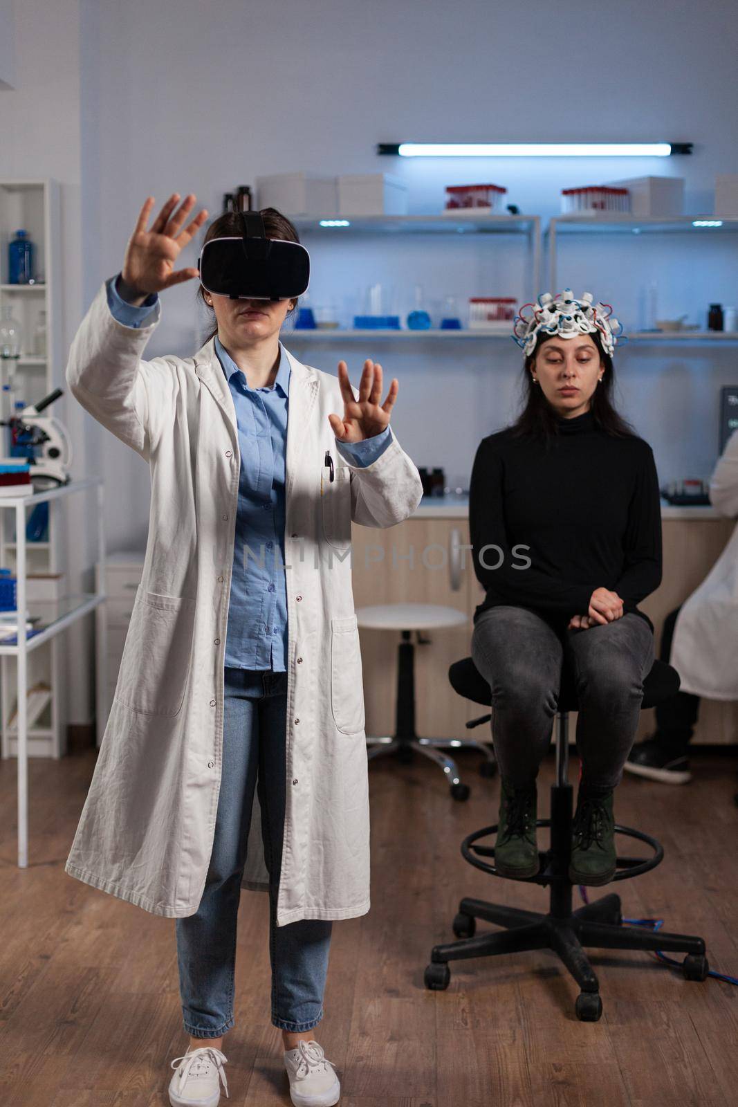 Neurologist doctor with virtual reality headset analyzing brain activity by DCStudio