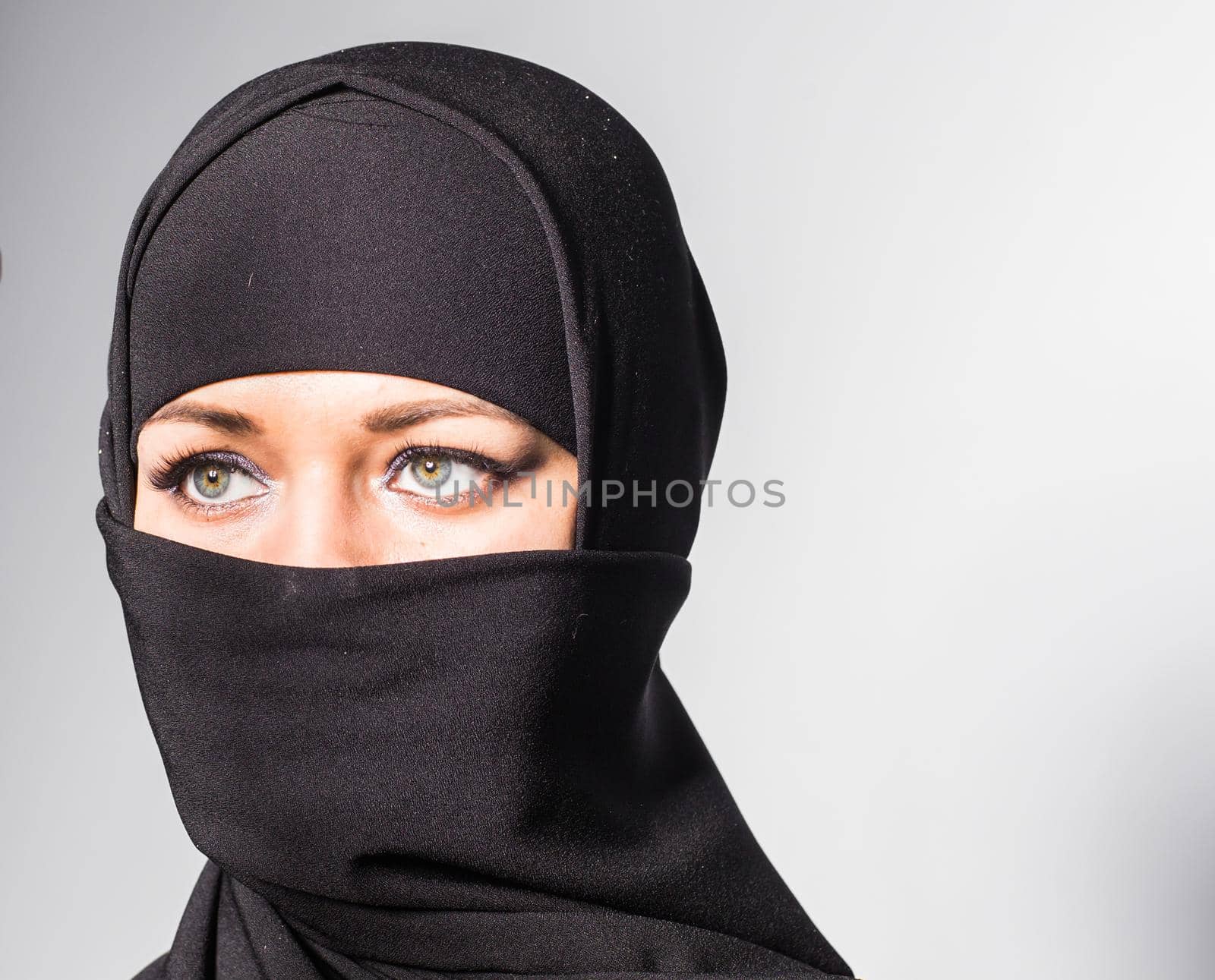 Beautiful girl with a scarf and black veil.