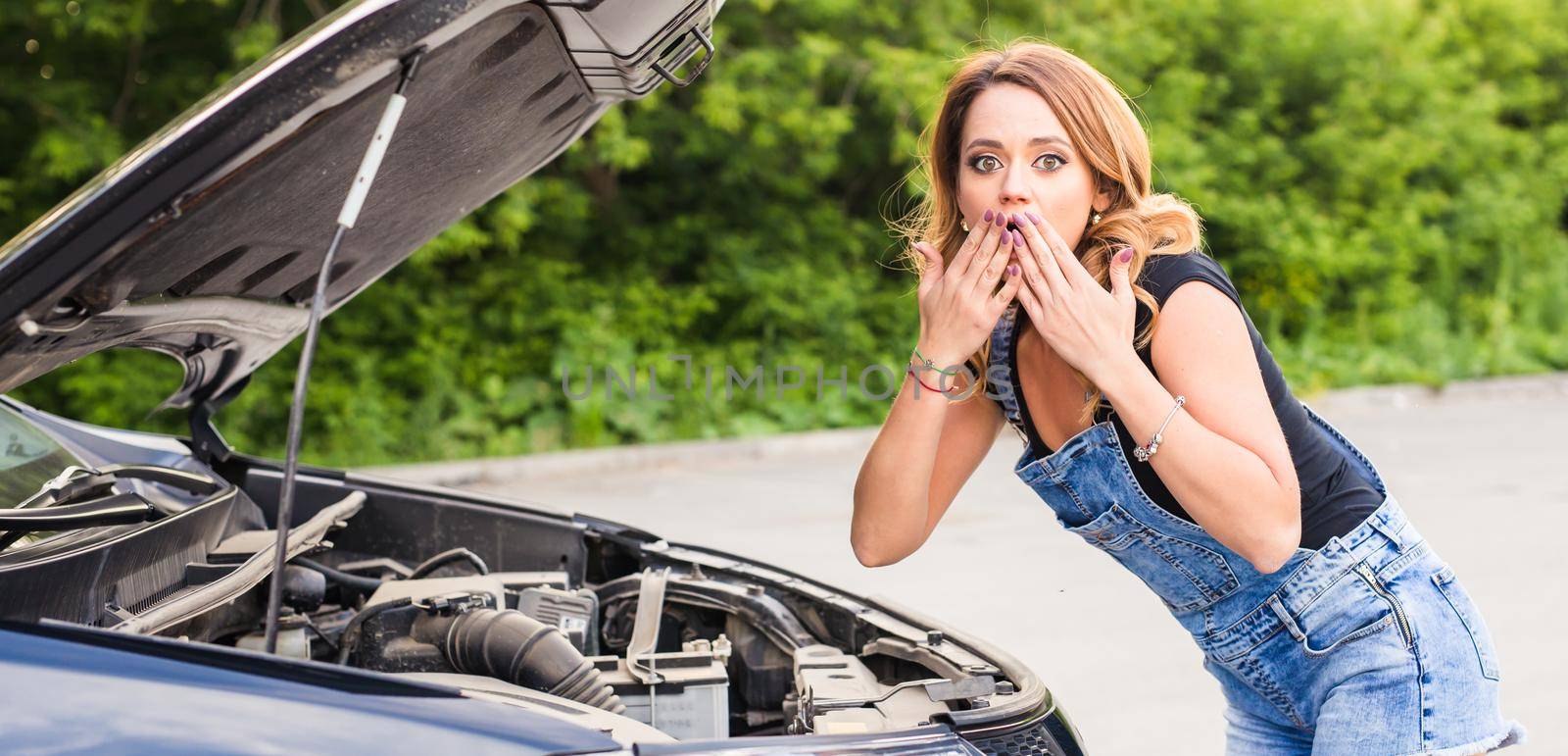 Broken car, accident, feeling confusion and people concept. Portrait of embarrassed young woman with broken car