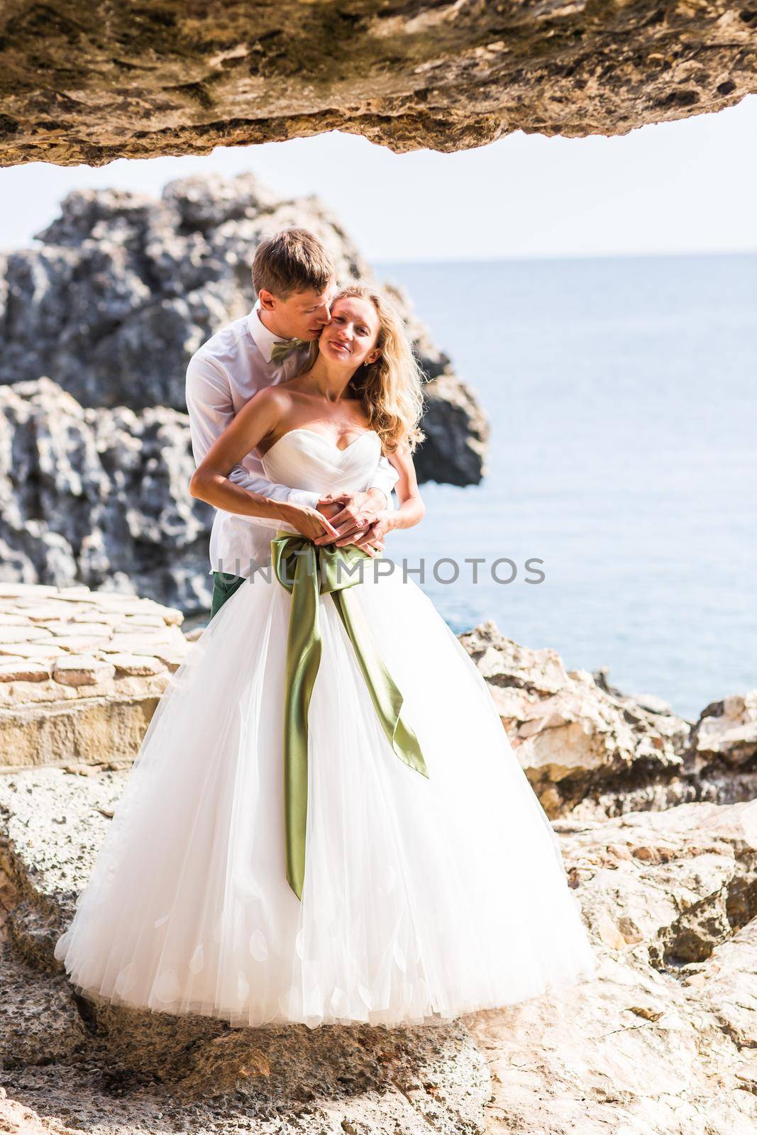 Sensual portrait of a young newlywed couple. Bride and groom outdoor.