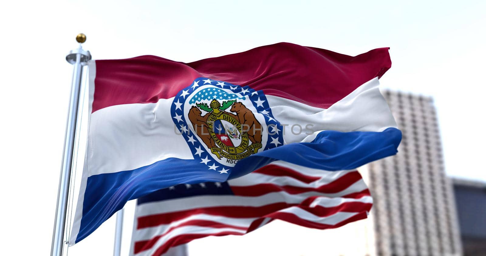 the flag of the US state of Missouri waving in the wind with the American flag blurred in the background. Missouri was admitted to the Union on August 10, 1821 as 24th state