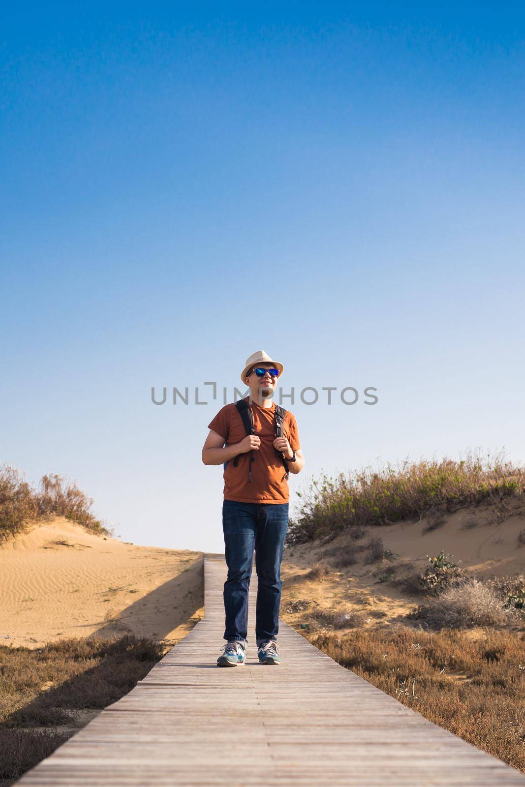 Young hipster man traveling backpacker outdoor. Travel concept