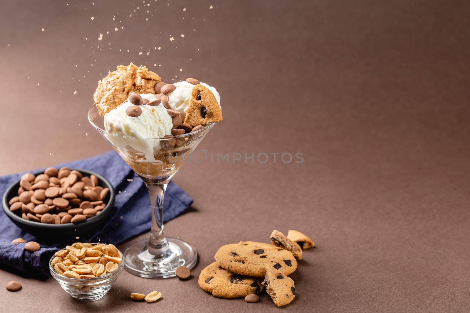 Homemade peanut butter ice cream with peanuts and chocolate cookies