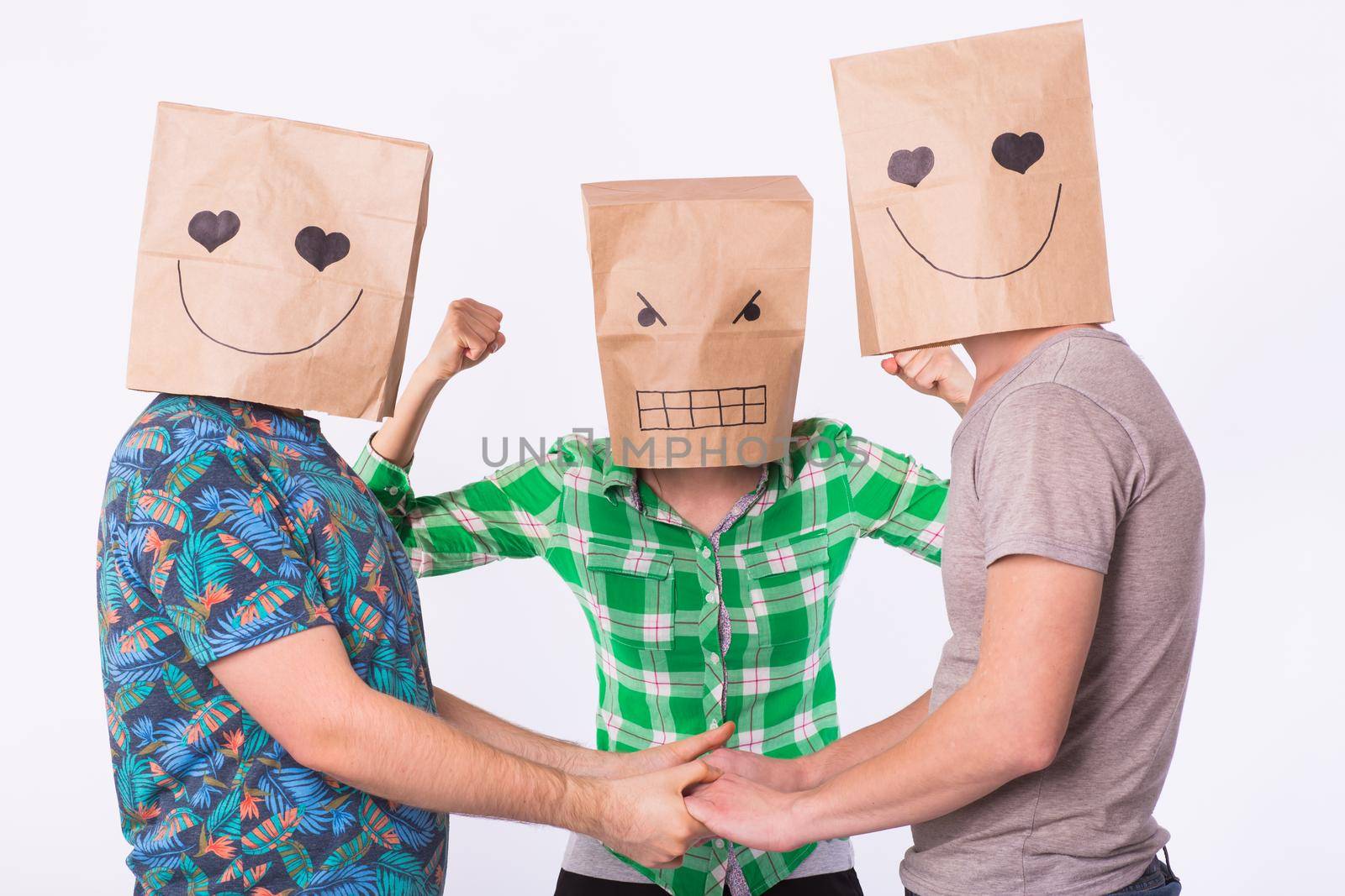 Love triangle, jealousy and homosexuality concept - gays with bags over heads holding hands and another woman is angry. by Satura86