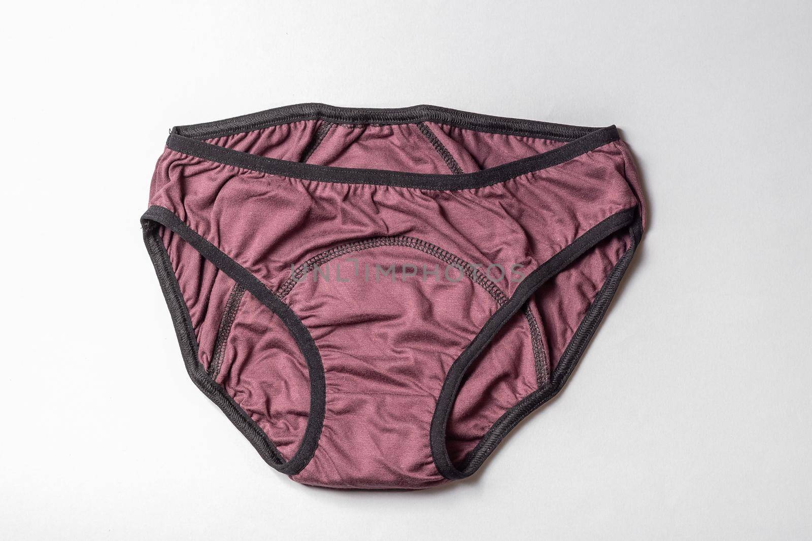 Reusable hygiene period menstruation underwear panties. Top view on gray background.