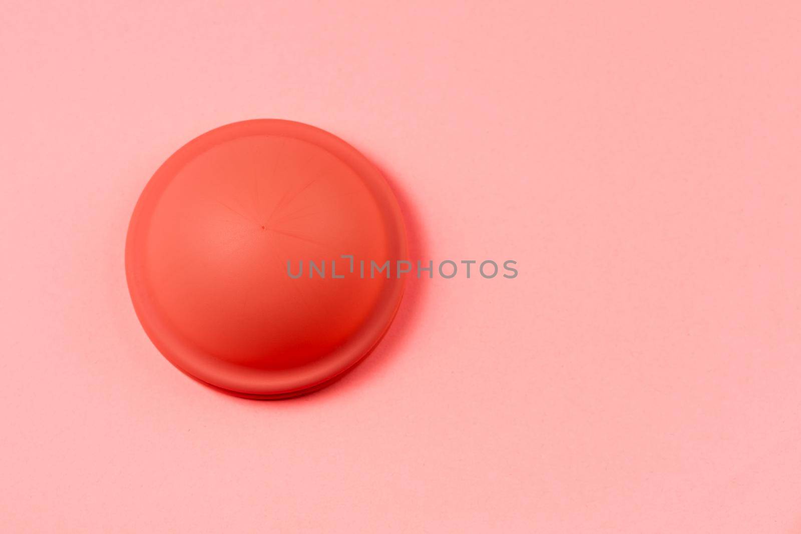 Menstrual Disk, reusable menstrual eco friendly product, pink background with copy space