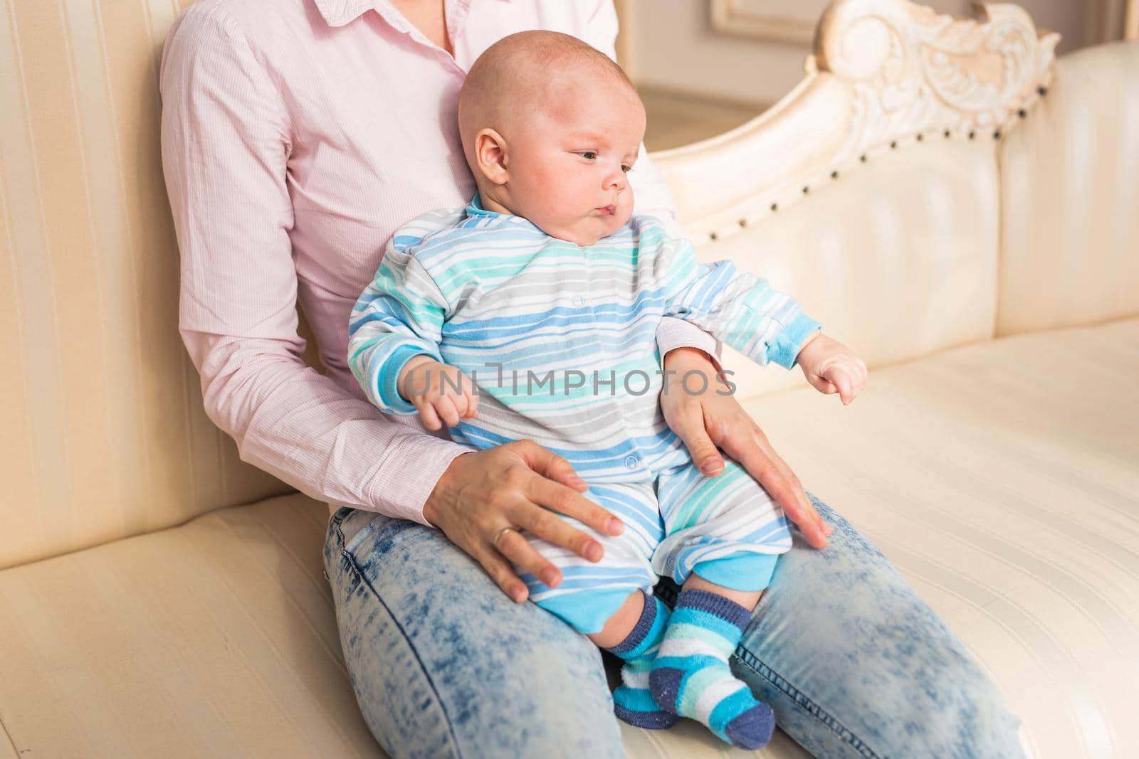 Portrait of young mother with cute baby at home.