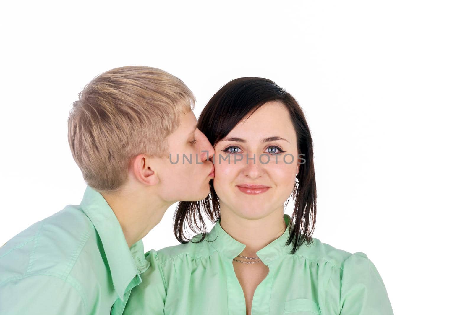 Young handsome guy kissing smiling brunette girl by lanych