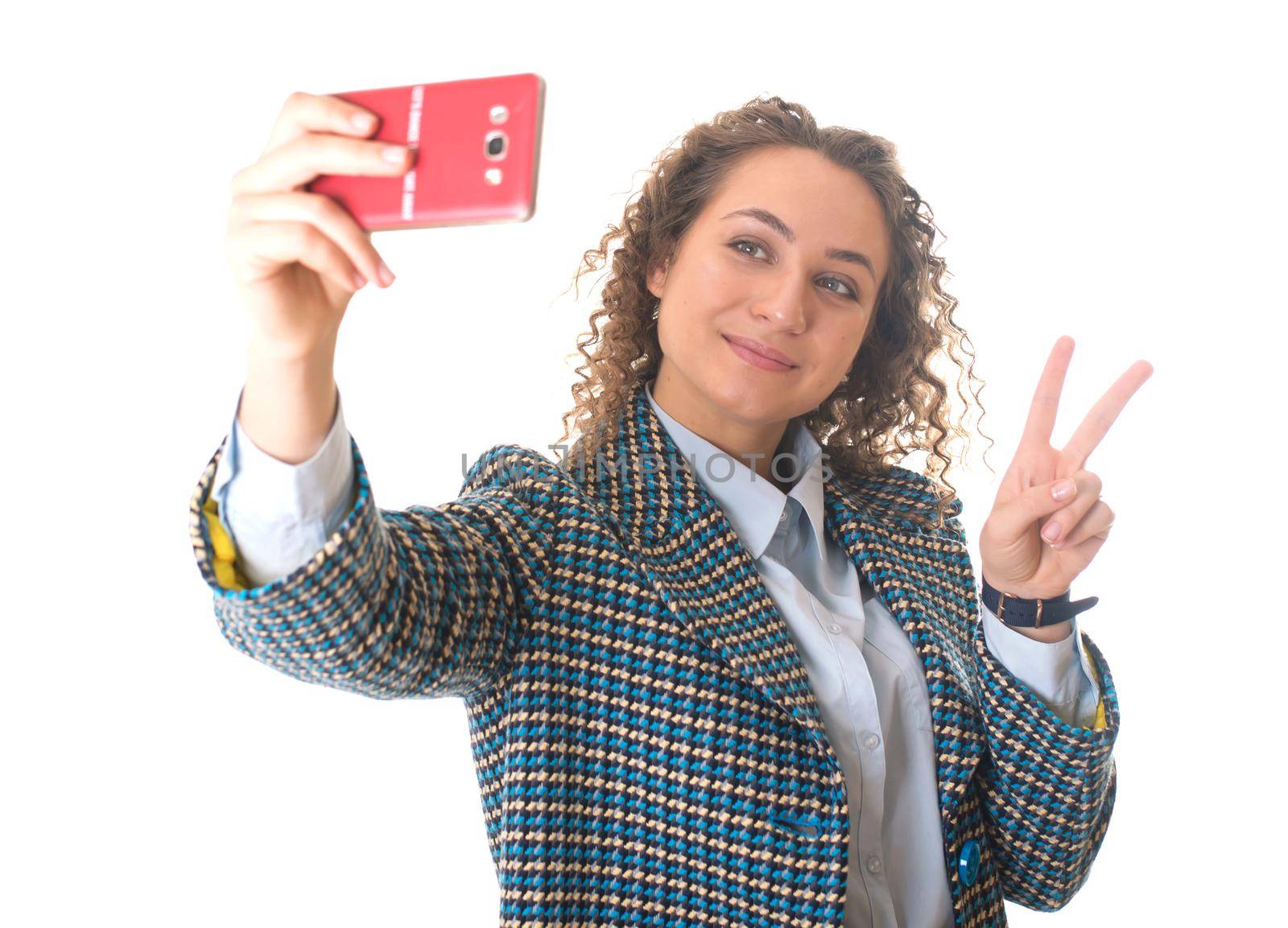 Close up portrait of a cute lovely woman taking selfie and showing peace sign with fingers over white background