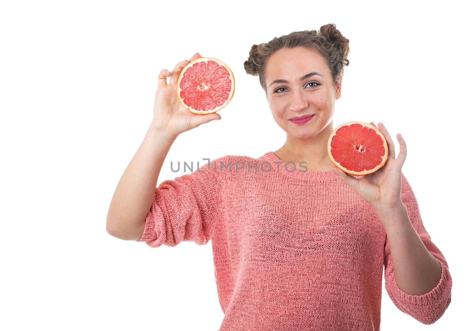 young girl holding fresh grapefruits on a white background by aprilphoto