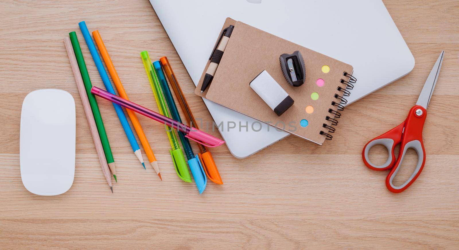 Back to school concept with school supplies laptop ,book, pen,mouse,and colored pencil on wooden table .
 by kerdkanno