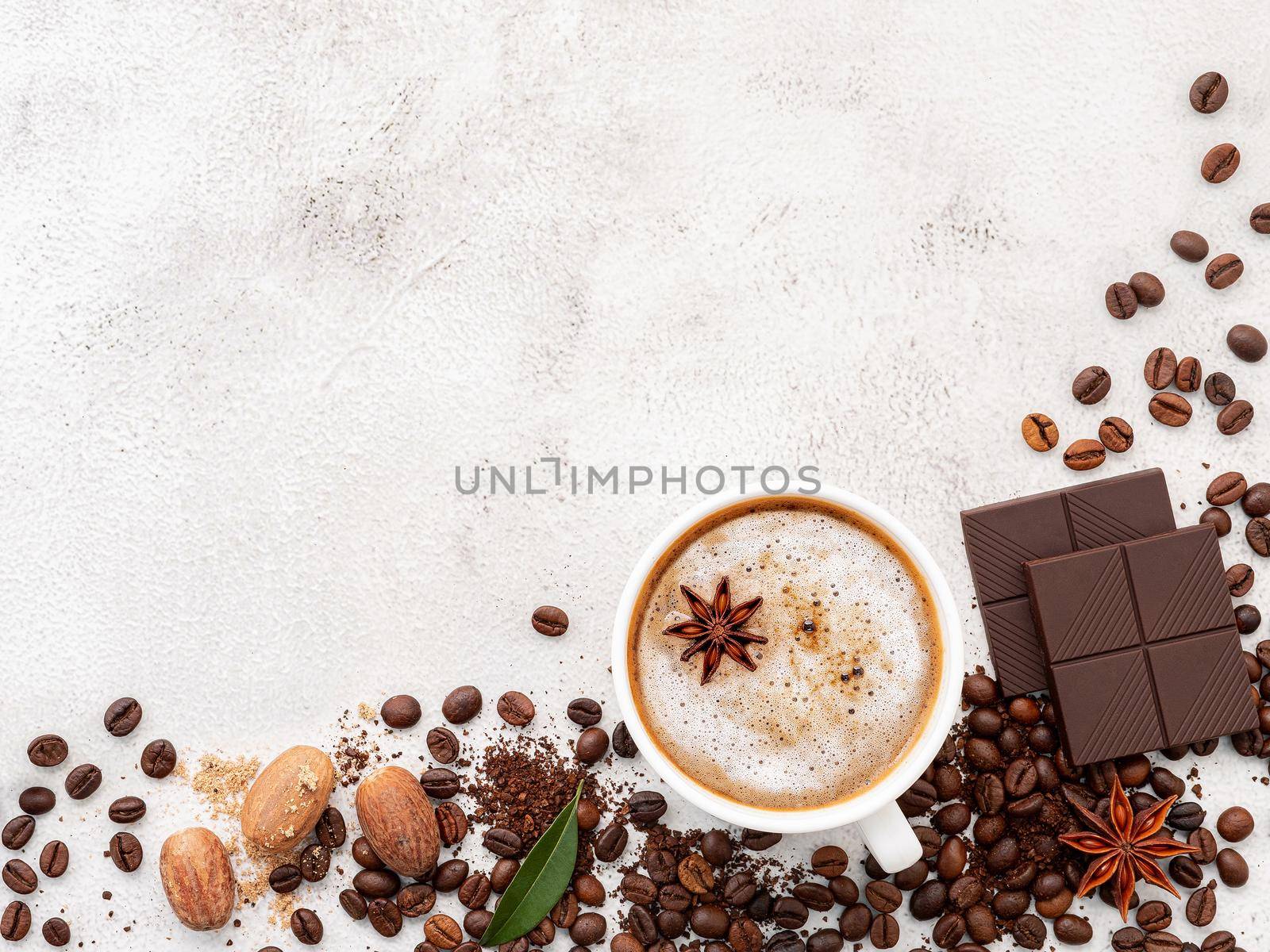Background of dark roasted coffee bean and with dark chocolate on white concrete background with copy space. by kerdkanno