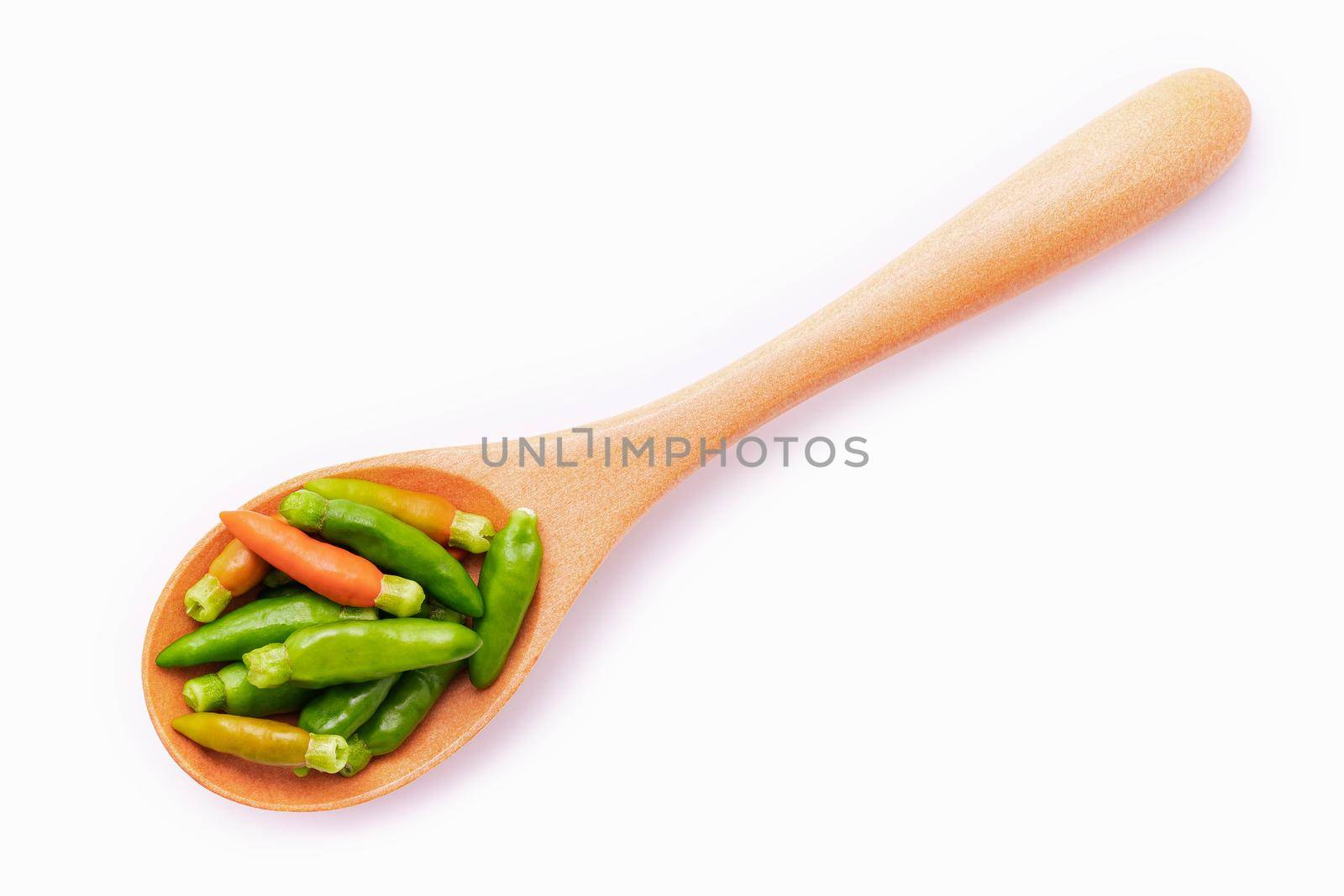 Fresh Thai bird's eye chillies in wooden spoon isolated on white background.