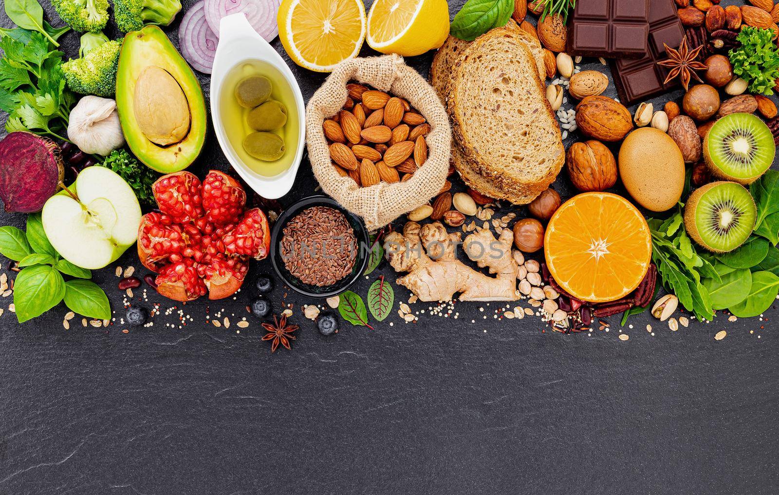 Ingredients for the healthy foods selection. The concept of healthy food set up on dark stone background. by kerdkanno