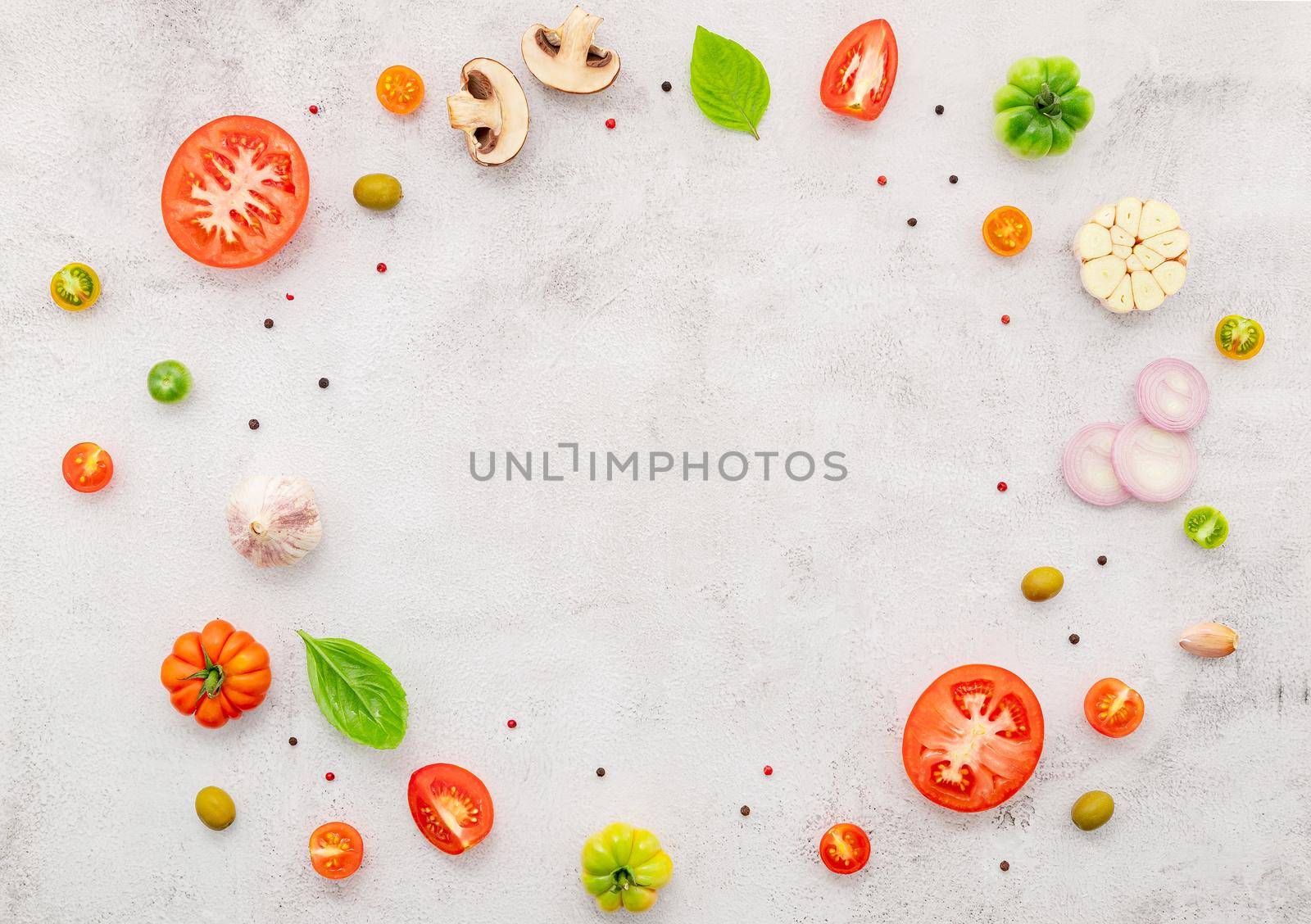 The ingredients for homemade pizza set up on white concrete background.