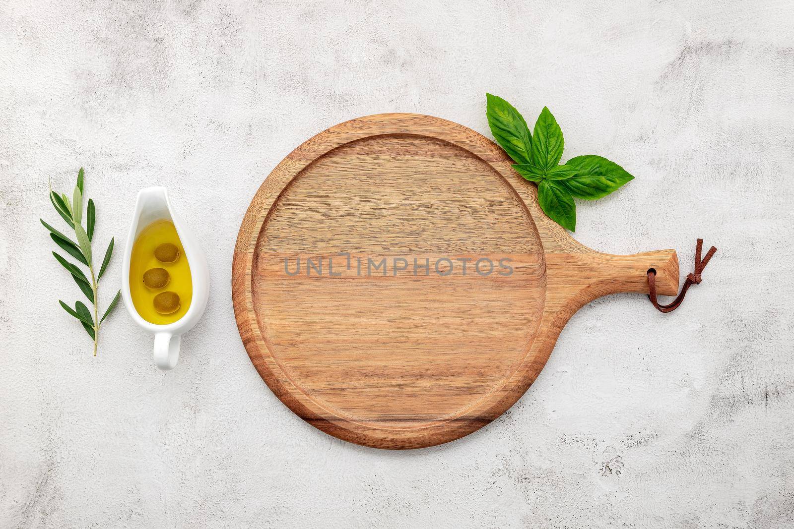 Empty wooden pizza platter set up on white concrete. Pizza tray on white concrete background flat lay and copy space.