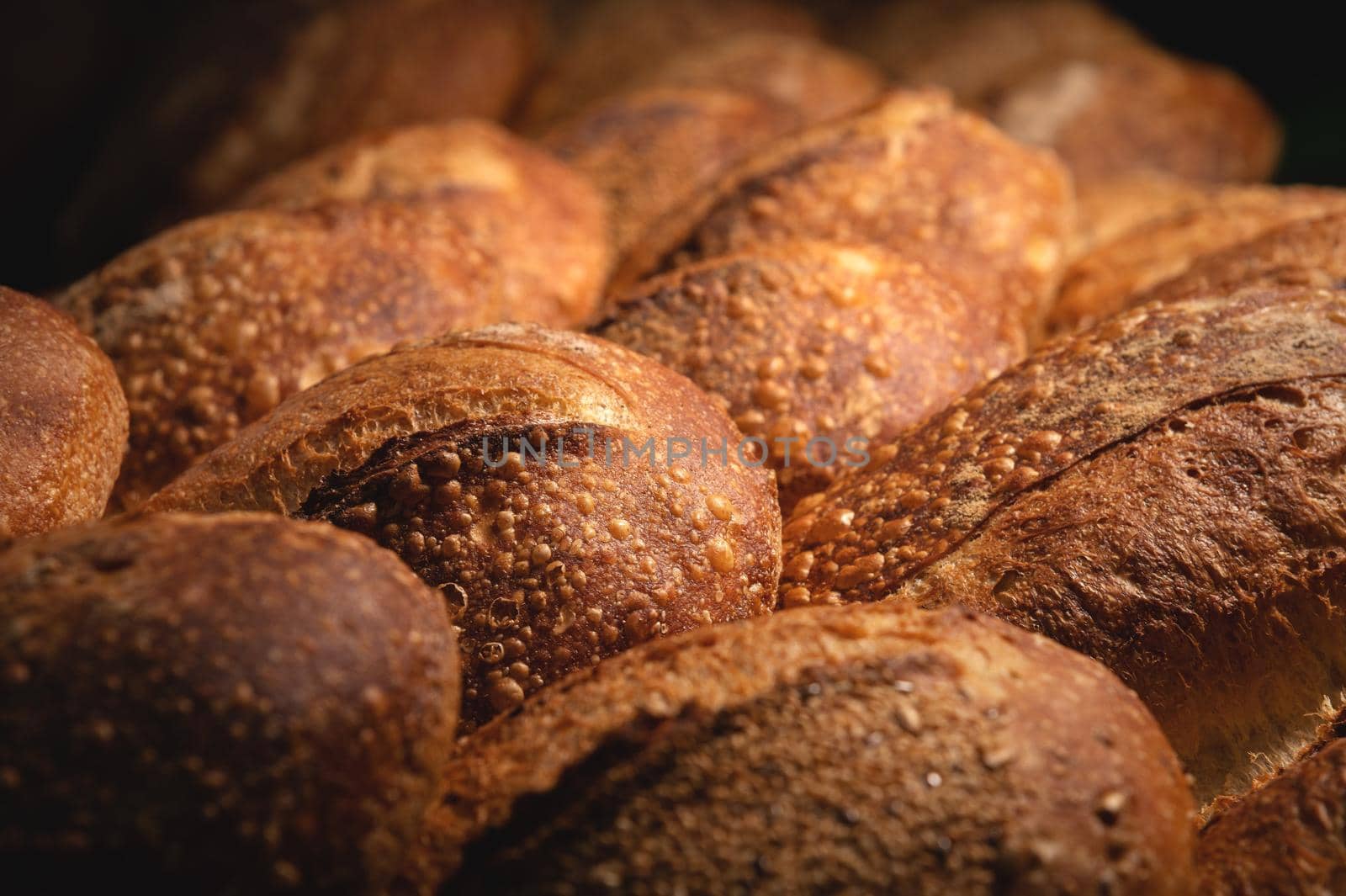 Freshly baked loaves of crispy artisan bread close up.