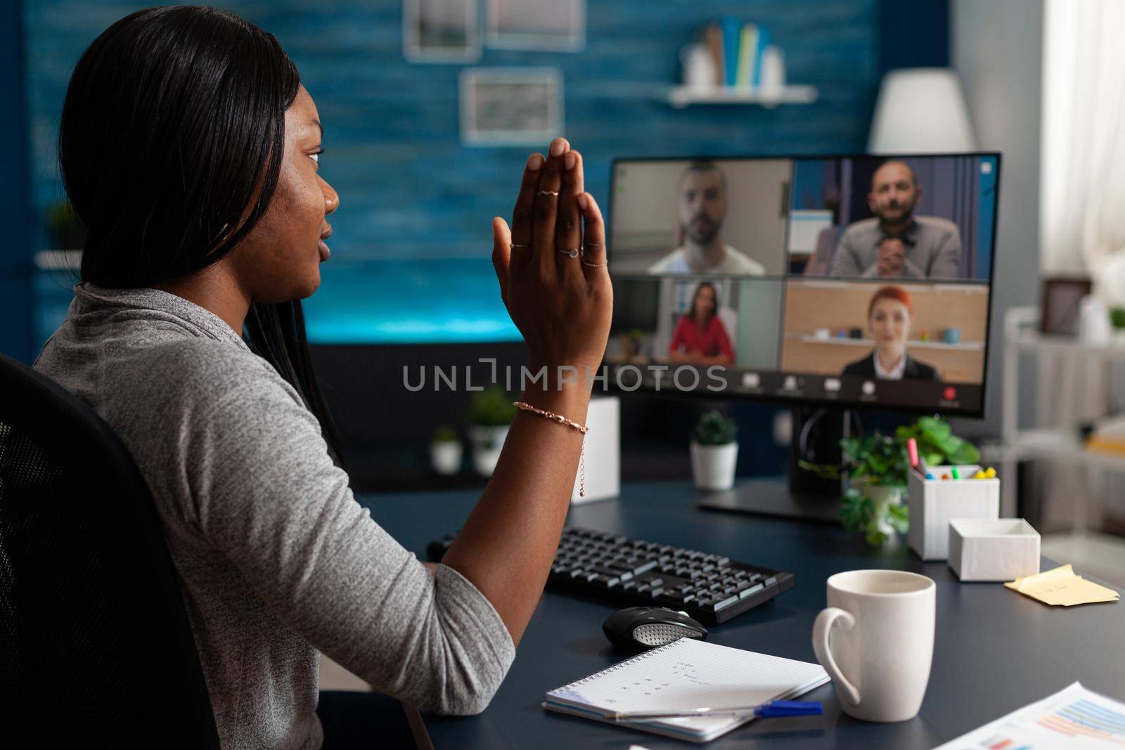 Person talking to workmates on video call to do teamwork project. Woman doing business meeting on online remote conference, working from home and using computer. Video communication