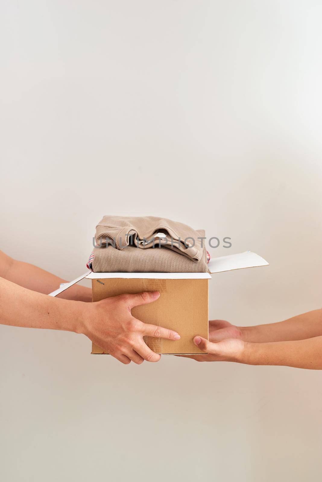 Man holding a clothes donate box. Donation concept.