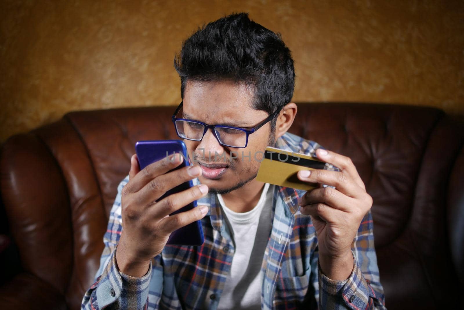 Man hand holding credit card and using smart phone shopping online .