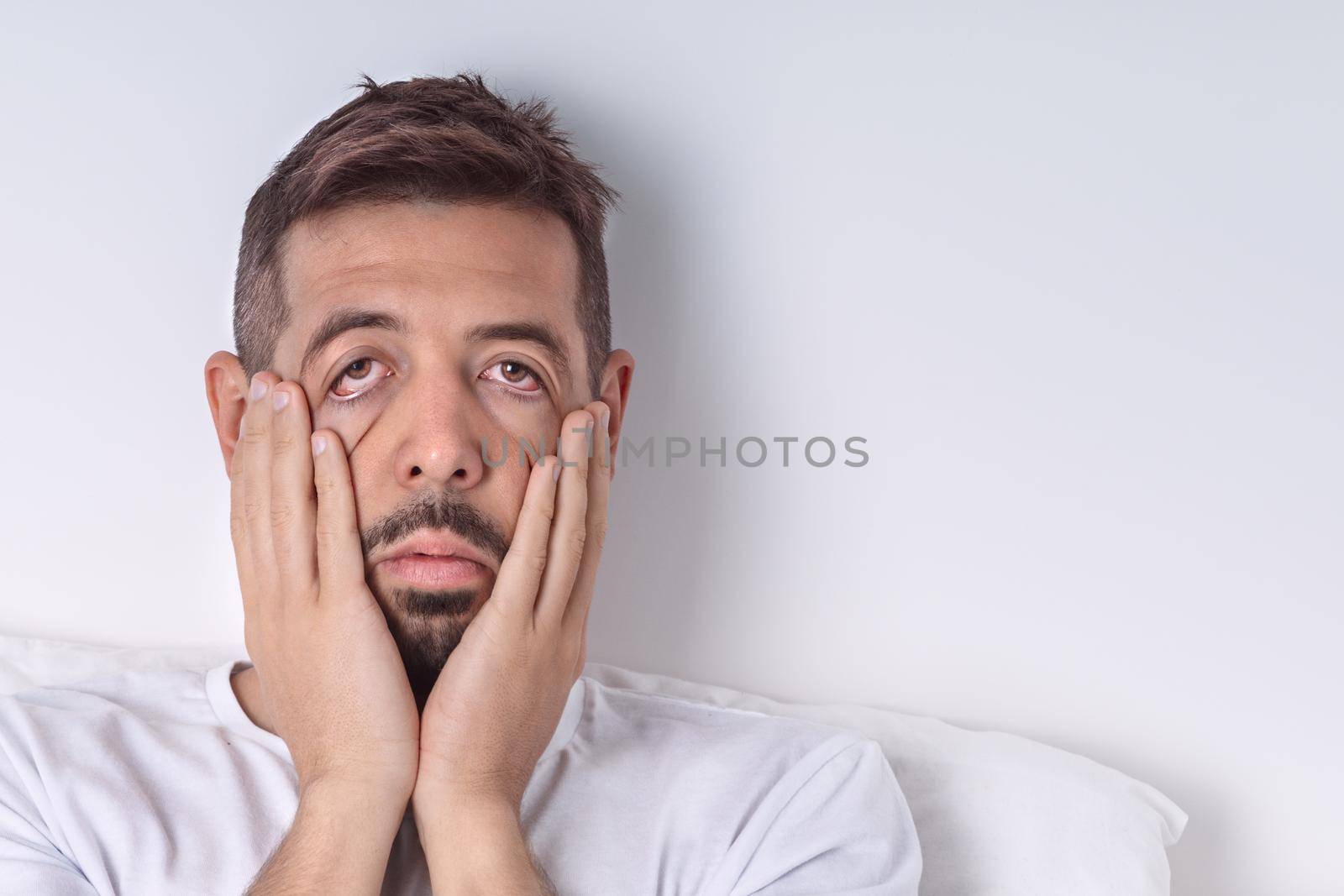 Exhausted sleepy man with chronic fatigue or hangover in the morning. Monday morning. Bad mood and bad morning. Copy space. High quality photo