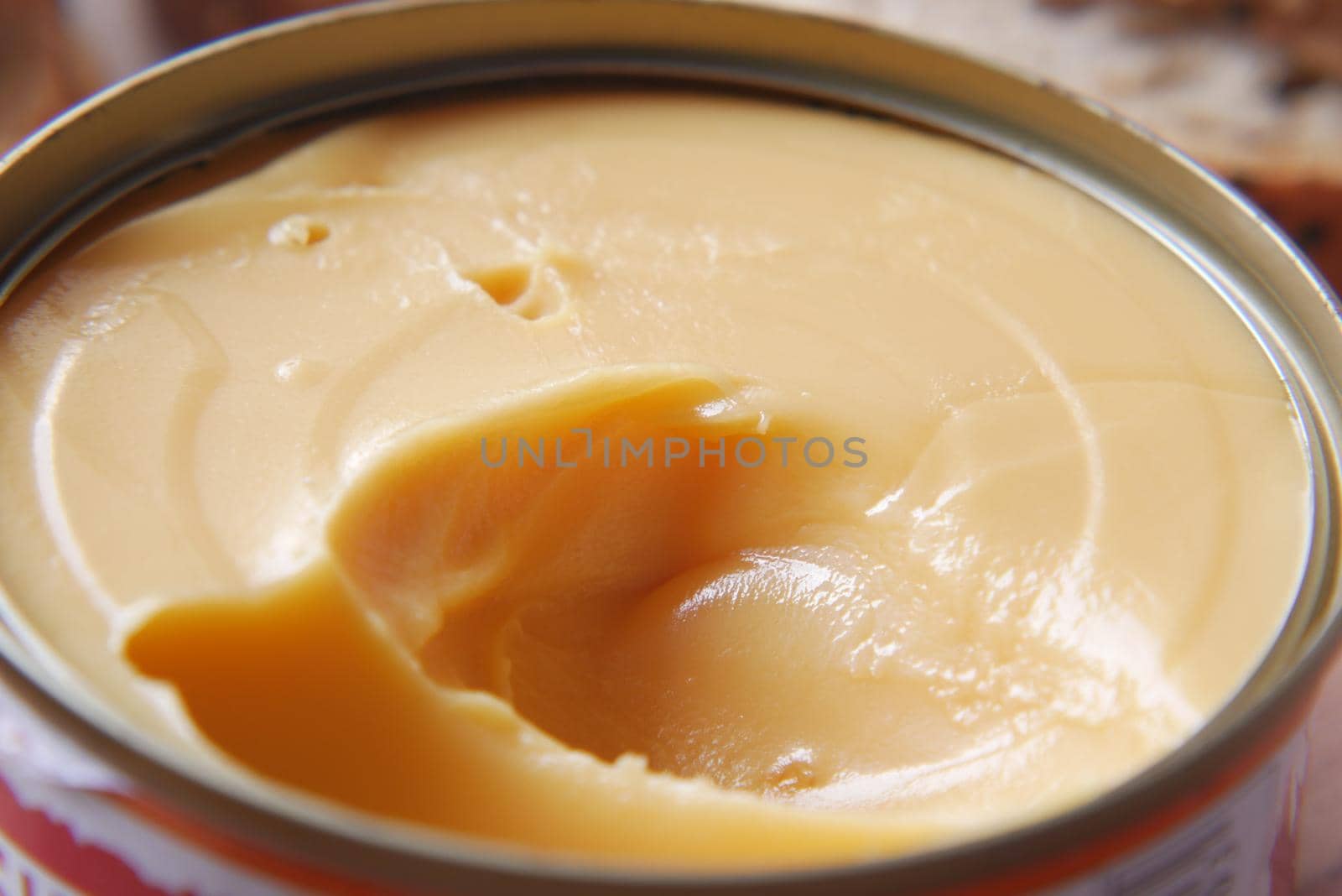 cheddar cheese in a tin container on table .