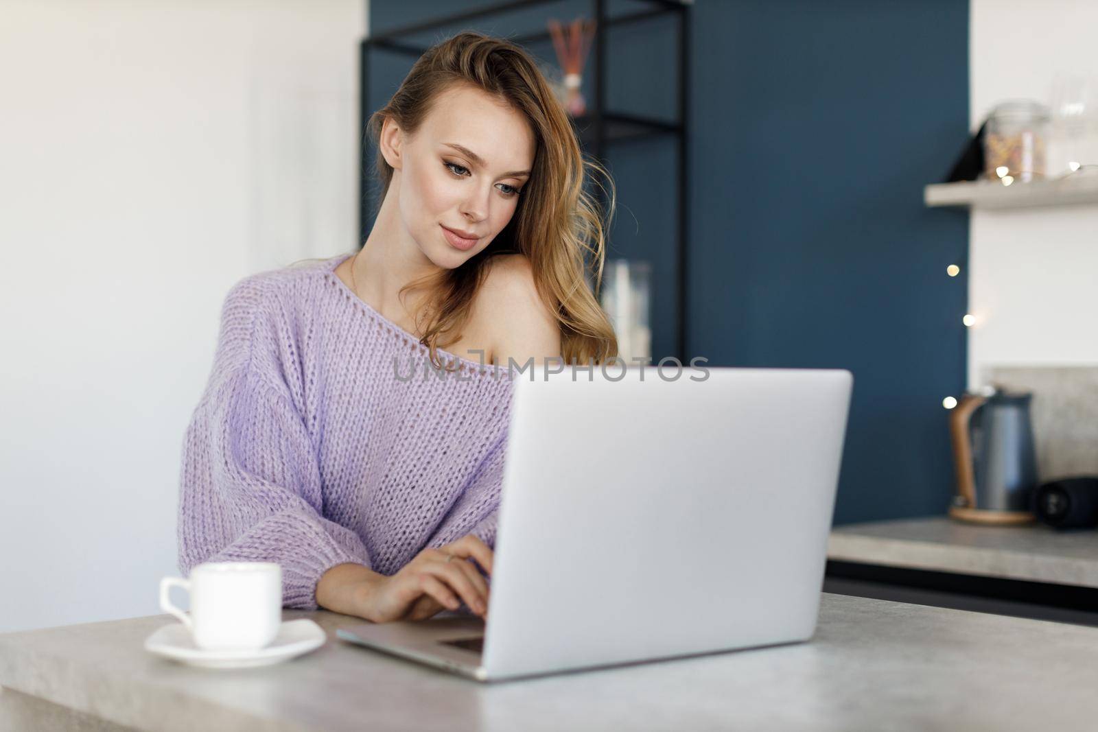 Young woman working at home, cozy portrait indoor. High quality photo