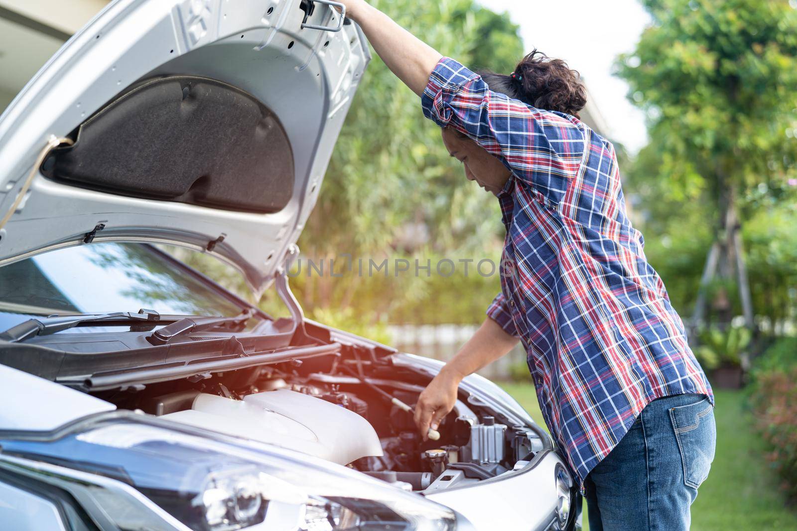 Open hood mechanic engine system to check and repair damage car crash.