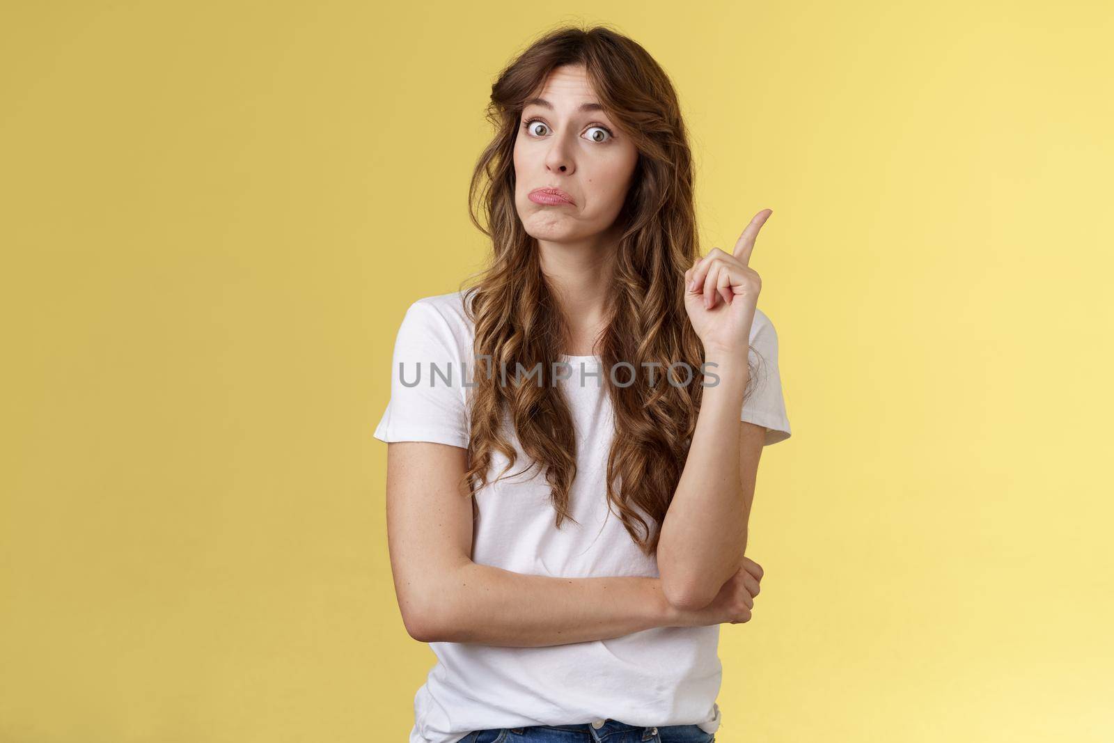 Hmm interesting advice thanks. Girl raise index finger pulling face not bad eureka gesture found great plan say suggestion make eureka sign stand yellow background share good recommendation.