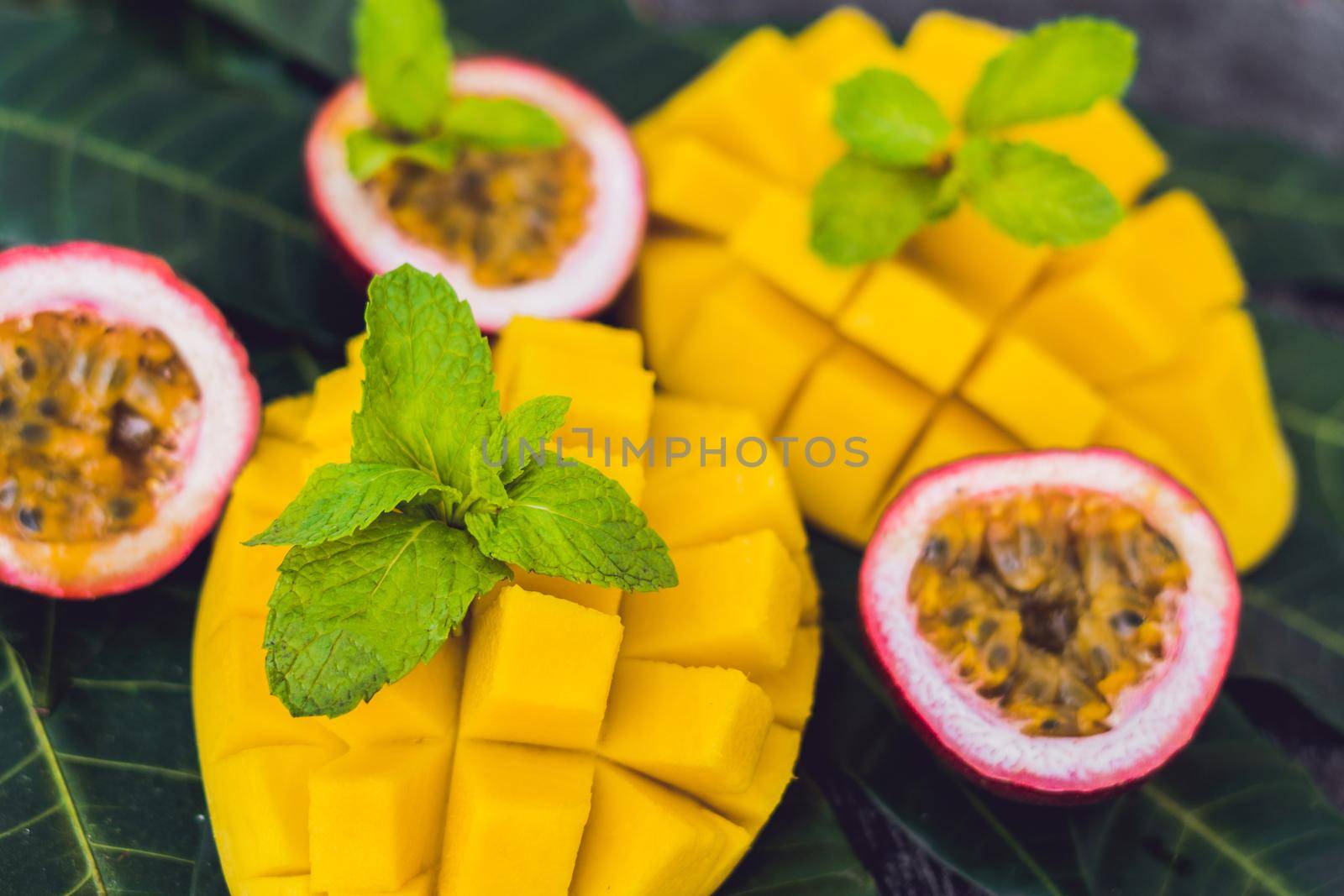 Mango and passion fruit on an old wooden background.