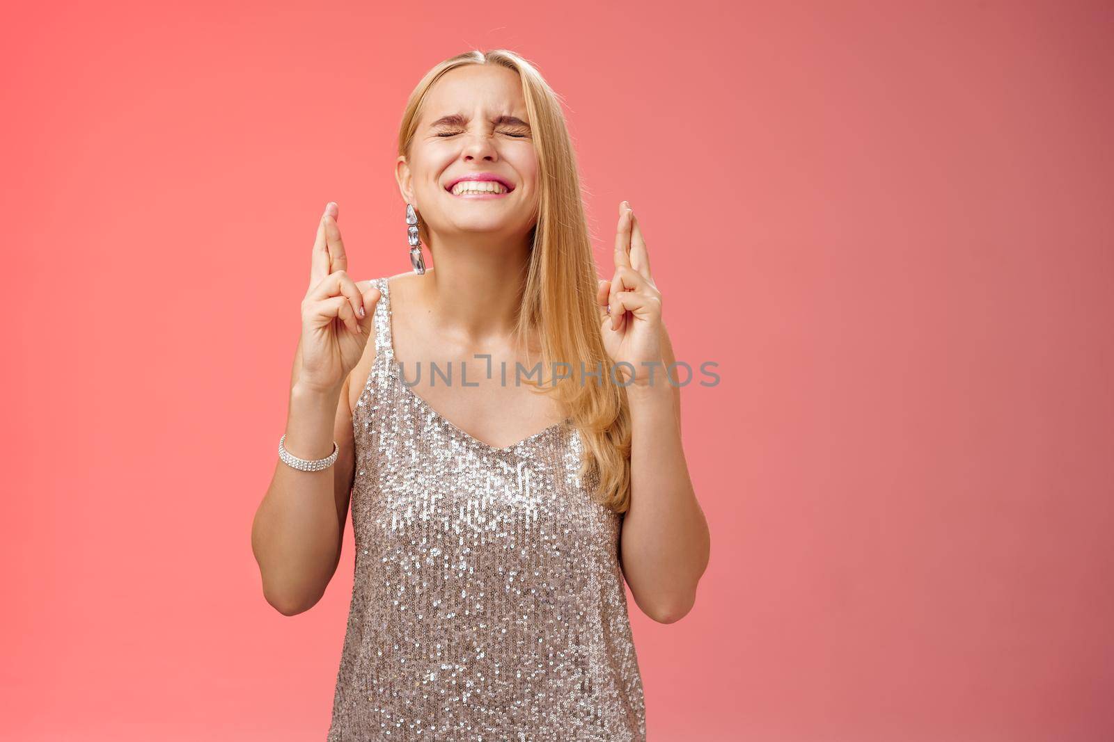 Worried blond woman put effort god hear prayers intense close eyes clench teeth raise head up praying supplicating cross fingers good luck wanna win dream come true making wish, red background by Benzoix
