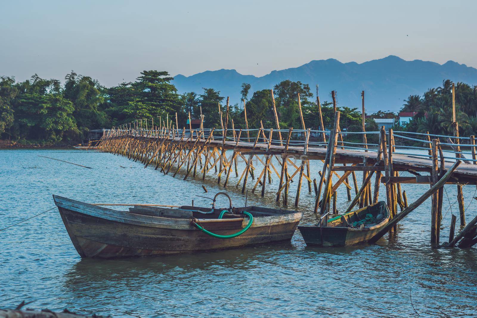 Old wooden bridge and wooden boat in Vietnam by galitskaya