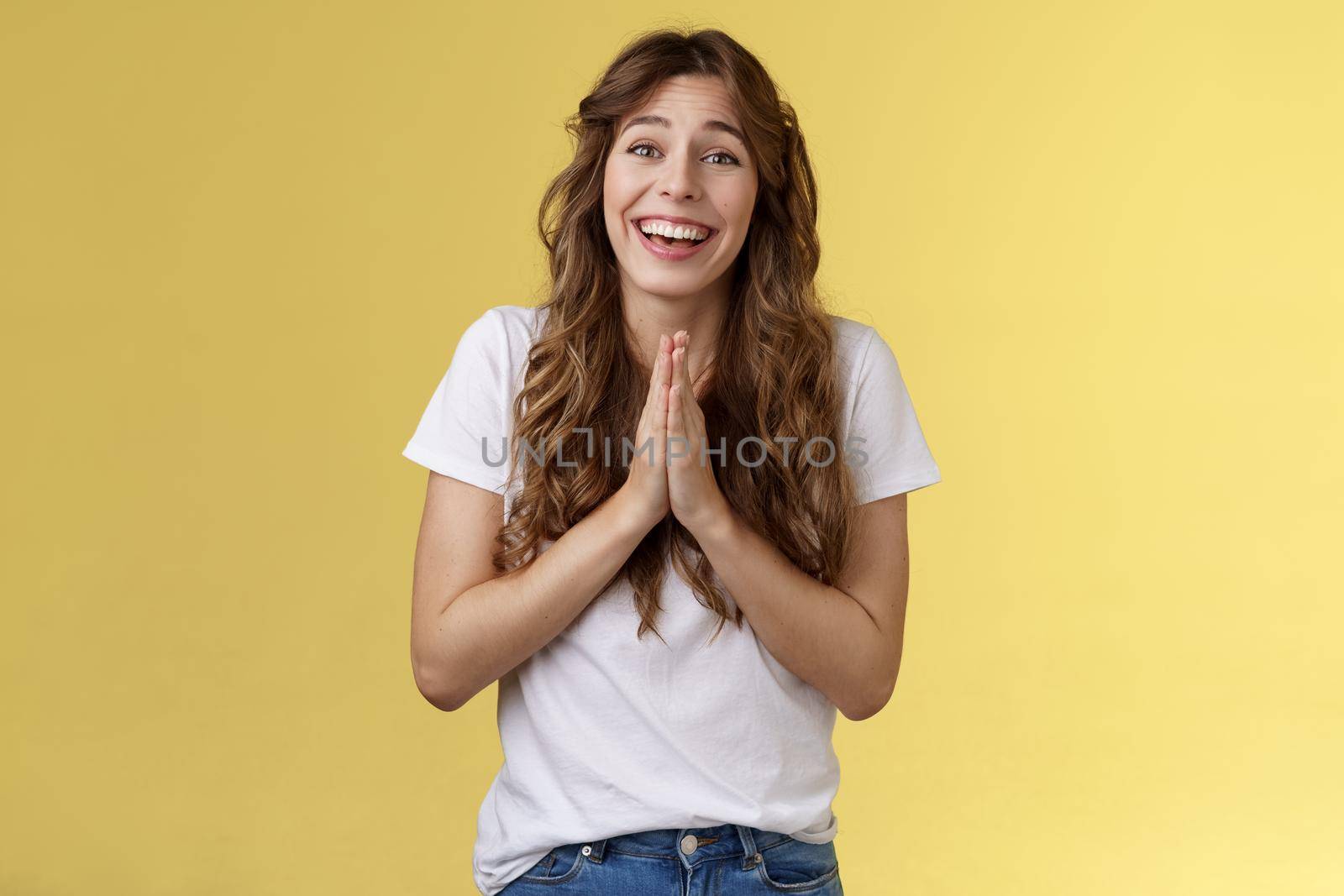Cheerful cute hopeful girl clingy begging look camera optimistic faithfully press palms together pray supplication gesture asking favour pleading apology positive lucky mood yellow background by Benzoix