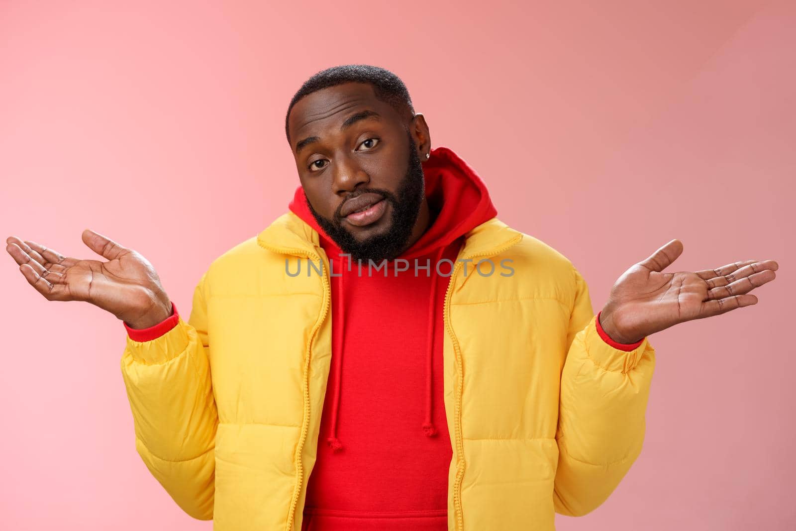 Indoor shot black bearded 25s guy shrugging hands raised sideways dismay clueless gesture have no idea standing careless questioned unaware what happened unbothered pink background. Copy space