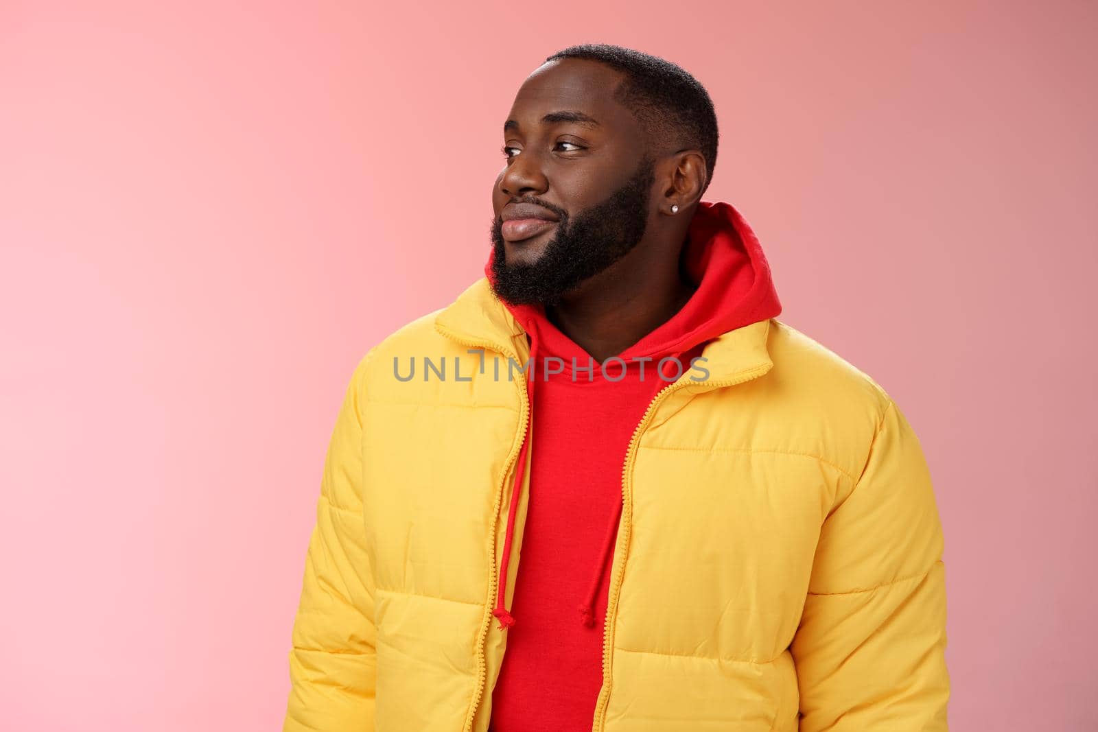 Dreamy happy optimistic black bearded man looking left daydreaming recalling nice moments, enjoying warm peaceful weather walking park feel calm relieved, standing pink background smiling cute.
