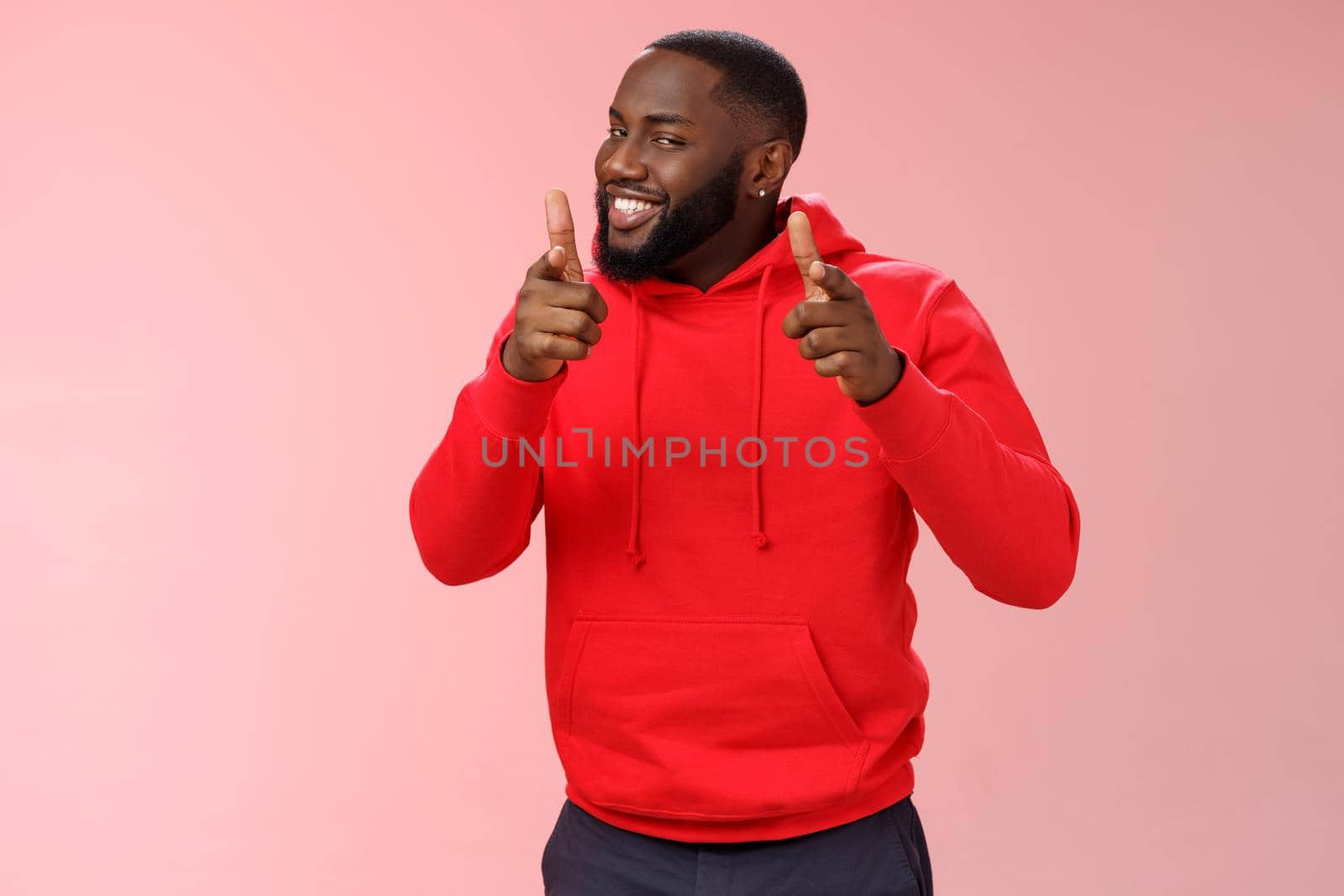 Nice work well done friend. Proud cheering good-looking cheeky young flirty black guy beard in red hoodie pointing finger pistols camera smug congratulating mate good game, standing pink background by Benzoix