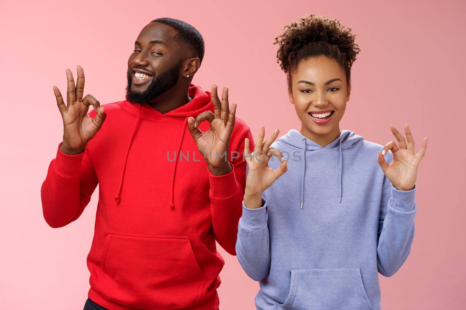 Everything perfect. Charming loving two couple relationship african american girlfriend boyfriend showing okay ok excellent gesture smiling approval assure parents they fine, pink background.