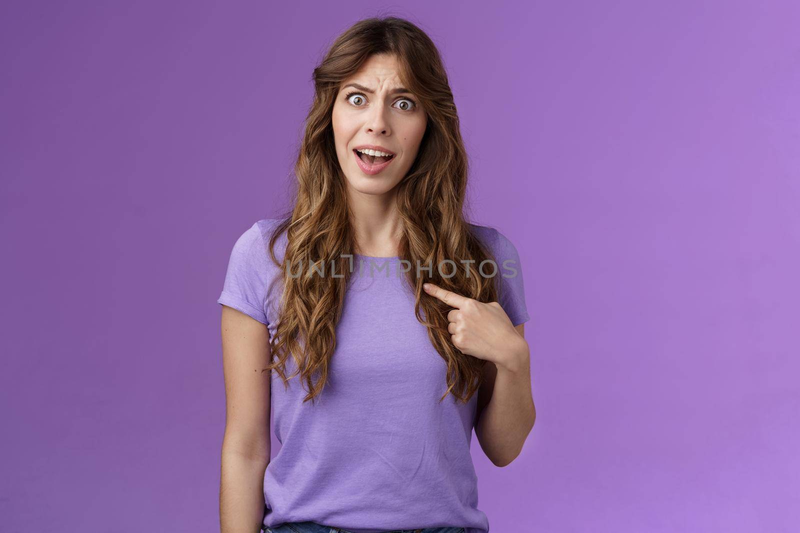 Accused frustrated upset shocked girl ambushed strange choice accusations pointing herself offended complaining frowning stand questioned displeased unfair decision purple background.