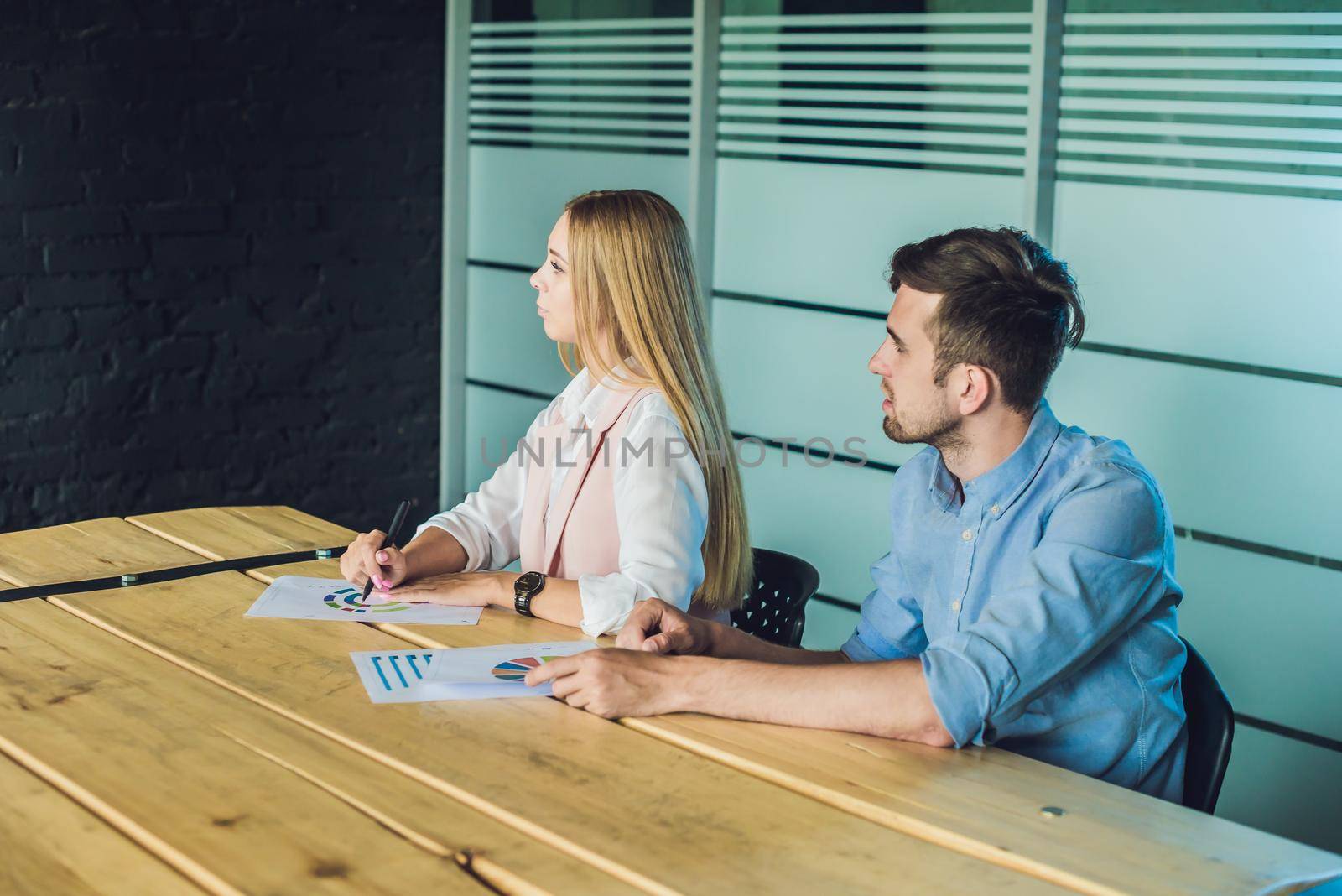 Young, attractive professionals having business training in the office