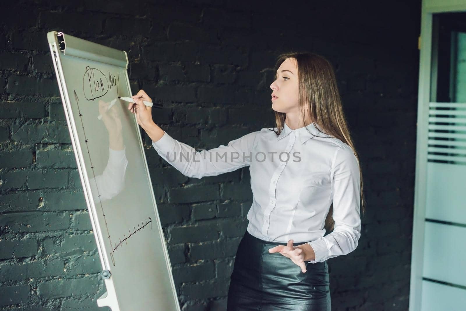 bussiness, meeting and education - businesswoman with flipchart in office.