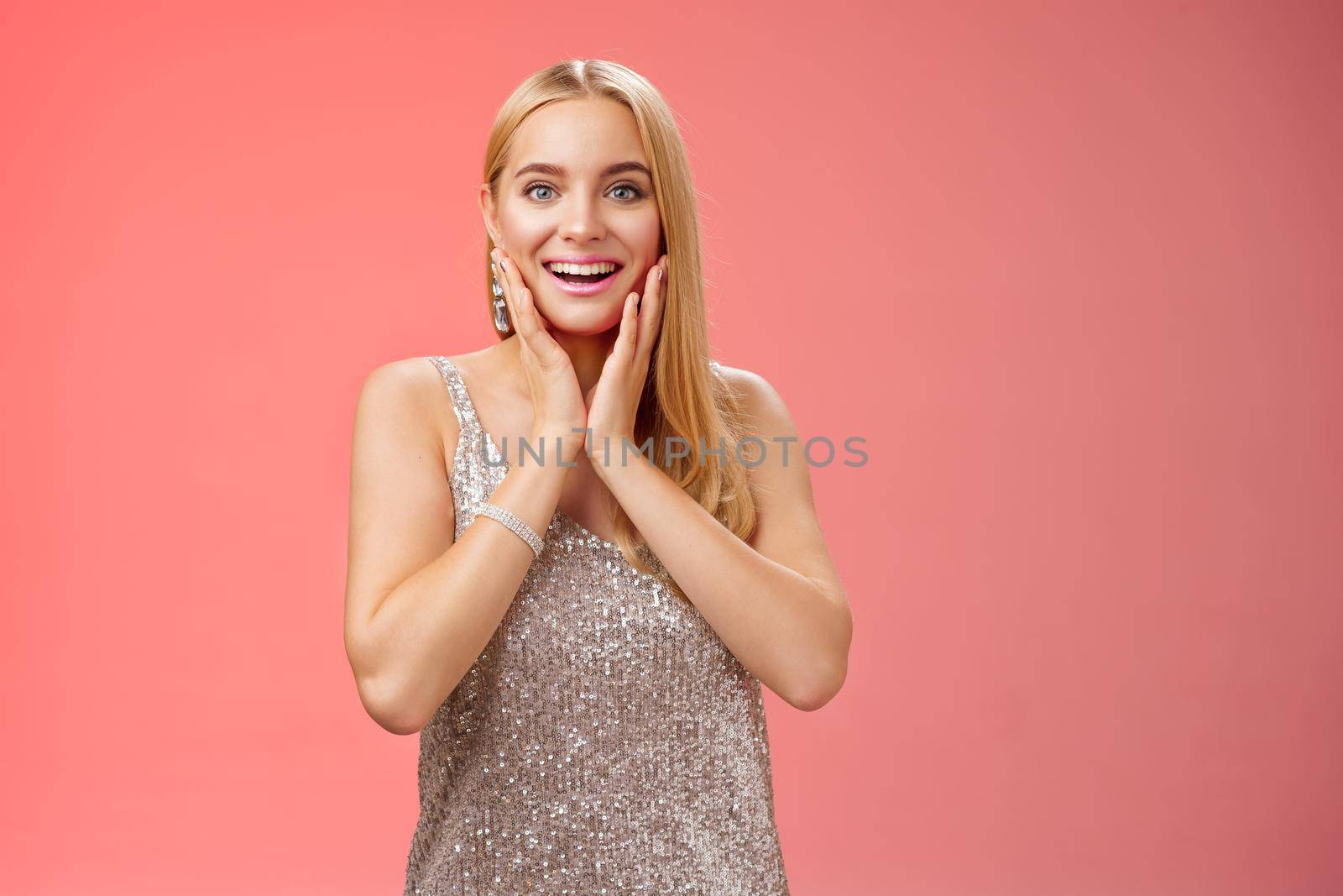 Amused gorgeous girlfriend surprised amazing stunning brilliant gift hold hand cheeks blushing look wondered astonished unbelievable generous present, standing glad smiling red background by Benzoix