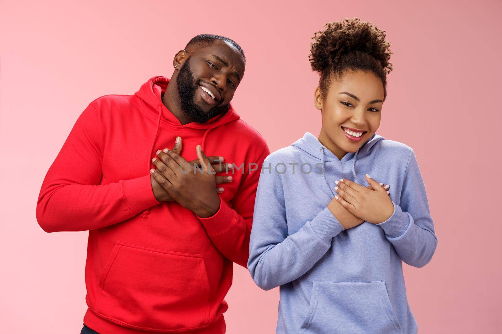Couple receive compliments look good together. Portrait charming friendly loving african-american girlfriend boyfriend press palms heart touched pleased smiling broadly grateful moving words.
