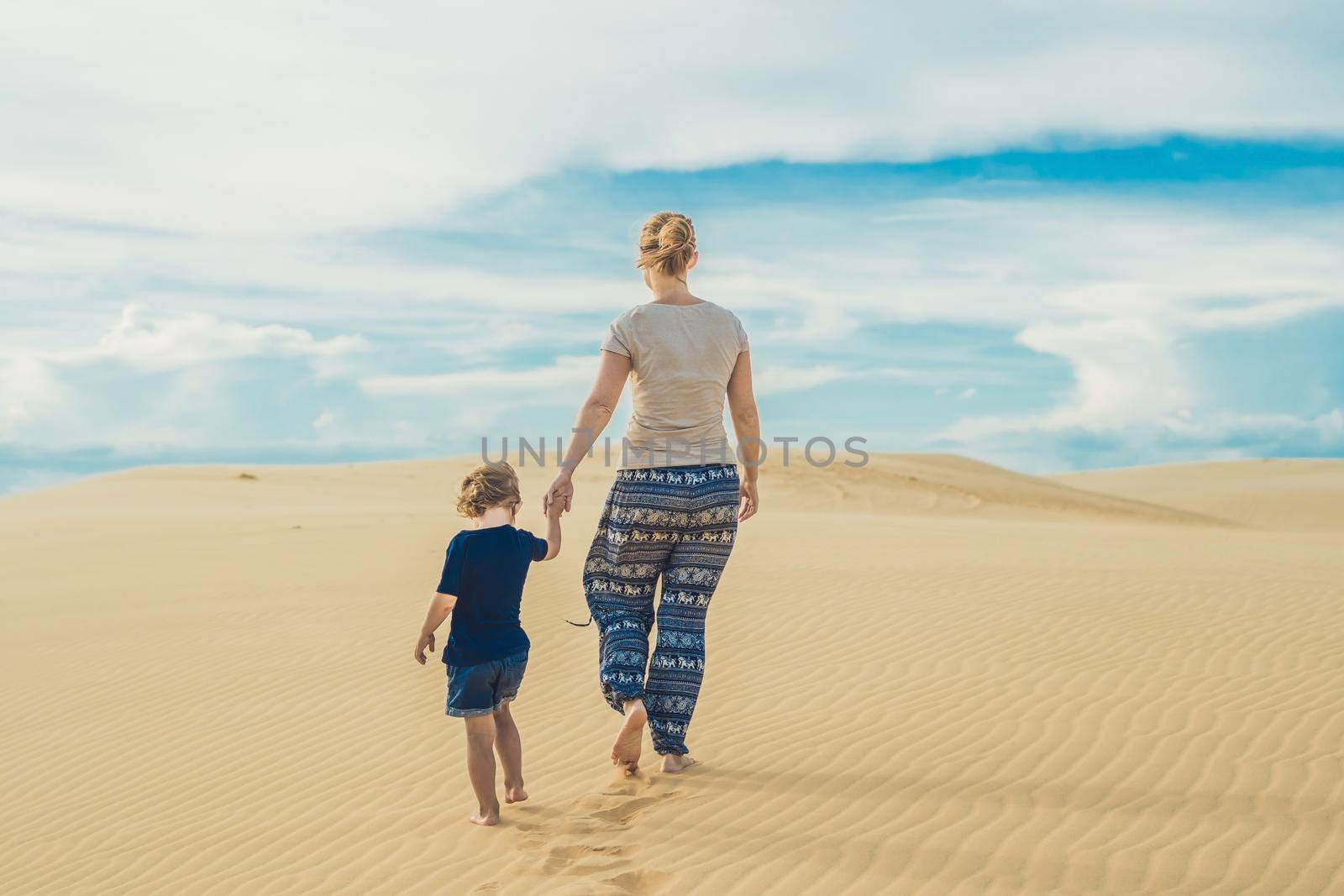 Mom and son in the desert. Traveling with children concept by galitskaya