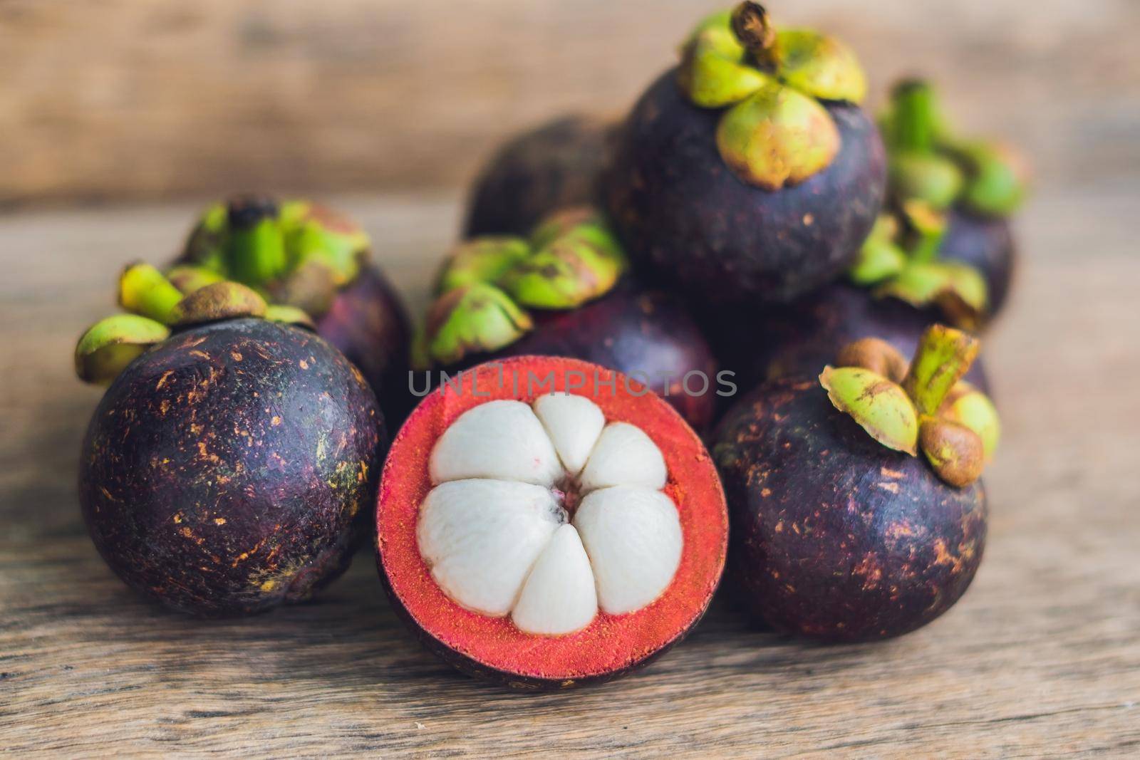 Mangosteen fruit on old wooden table. Tropical Fruits.